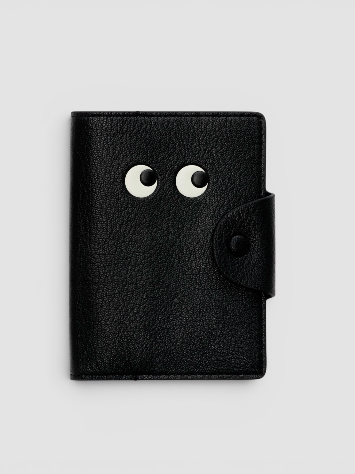 Anya Hindmarch Eyes Leather Passport Case in black.