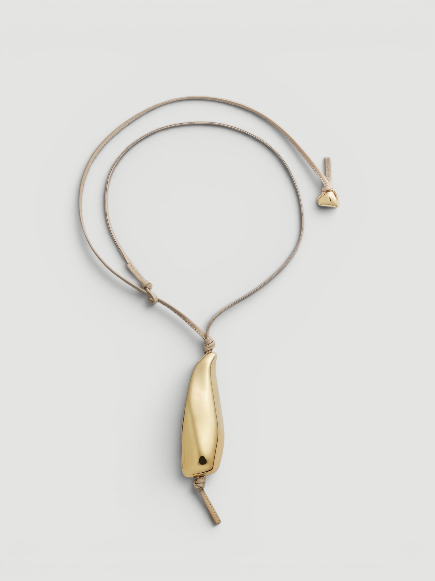 Bottega Veneta Prisma Necklace in gold / leather cord. Styled by Sharon Lombardo for FDV Concierge.
