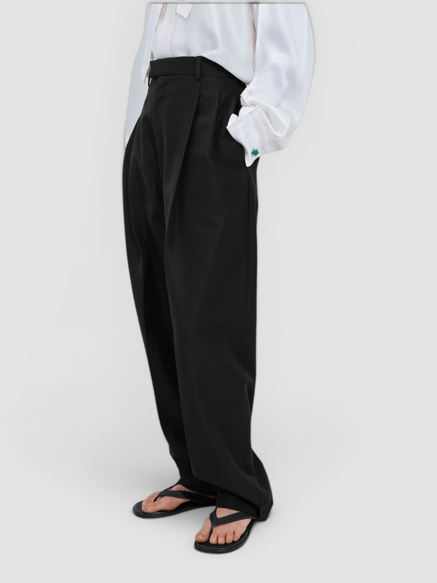 Bottega Veneta Sampieri Flat Thong in black, worn with Phoebe Philo Silk Shirt, Phoebe Philo Wide-Leg Jeans, Phoebe Philo Peak Sunglasses, Phoebe Philo Small Stud Cabas Tote Bag, on the water. Styled by Sharon Lombardo for FDV Concierge.
