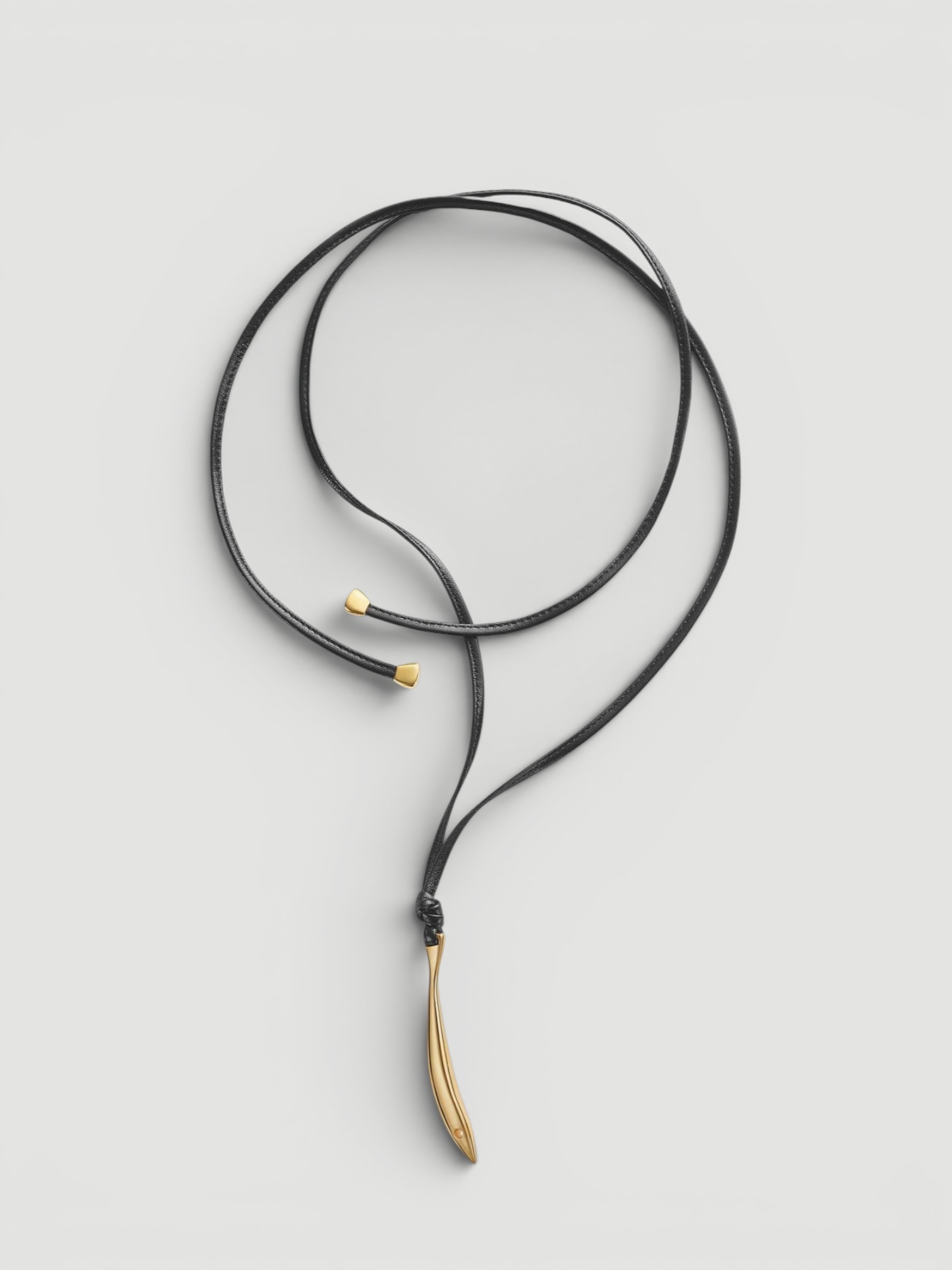 Bottega Veneta Sardine Leather Necklace in black / gold, worn with Toteme Lyocell-Blend Tapered Pants, Róhe Off Shoulder Lapel Top, Bottega Veneta Salsa Thong, Phoebe Philo Gig Leather Shoulder Bag, the evening. Styled by Sharon Lombardo for FDV Concierge.