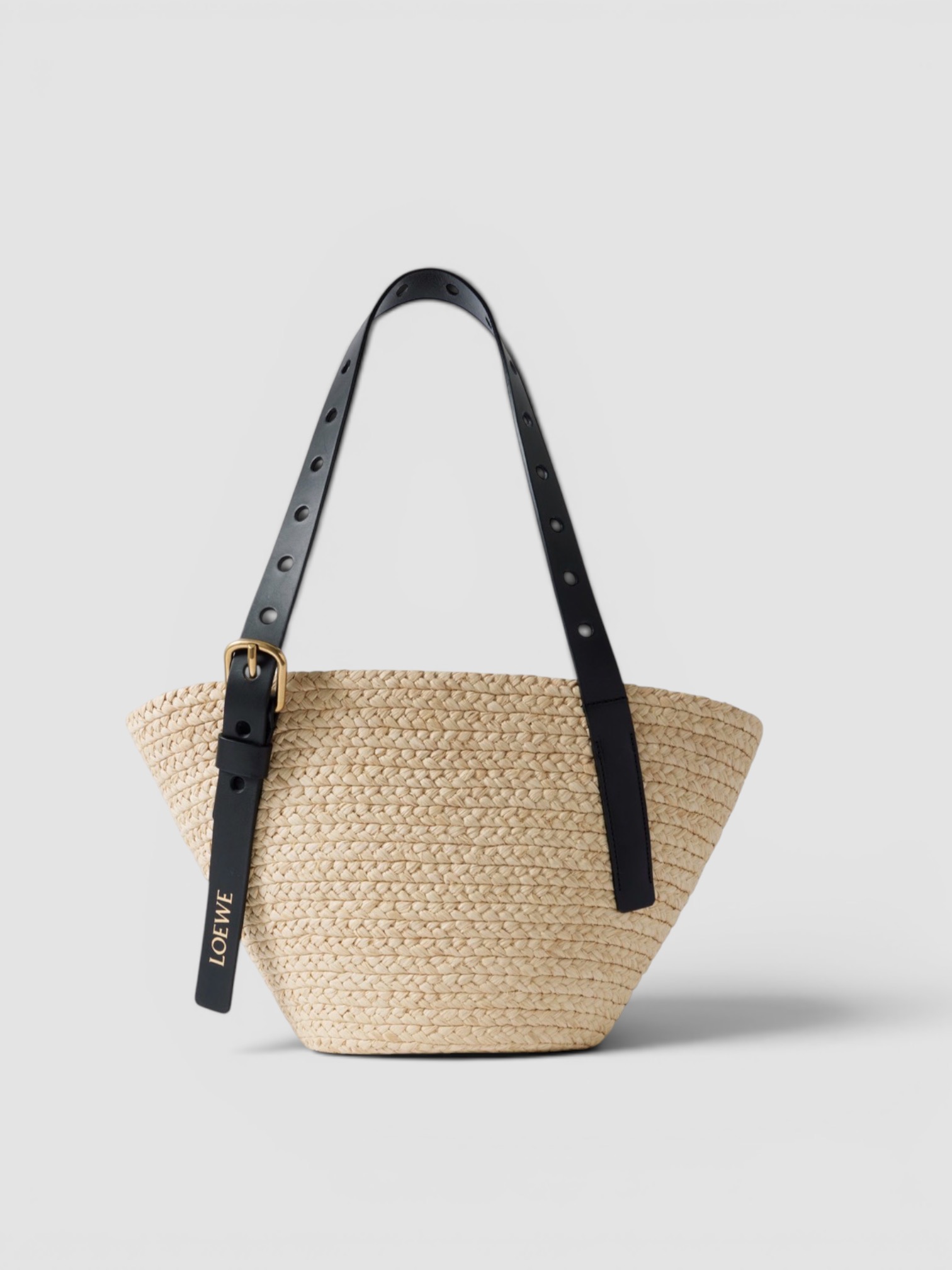 Loewe Paula's Ibiza Punch Hole Small Leather-Trimmed Raffia Tote in beige, worn with All Three Kristen Rib Tank, Totême Wide Summer Trousers, St. Agni Fringed Leather Belt Skirt, Bottega Veneta Sampieri Flat Thong, on the water. Styled by Sharon Lombardo for FDV Concierge.