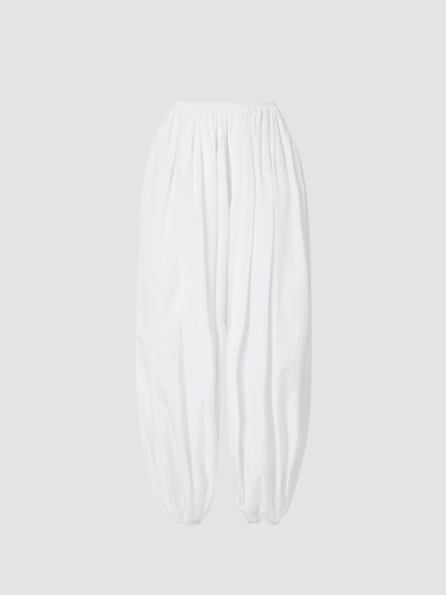 Alaïa Balloon Pants in white, worn with Alaïa Cropped Jersey Turtleneck Tee, Alaïa Wedge Thong Mule. Styled by Sharon Lombardo for FDV Concierge.