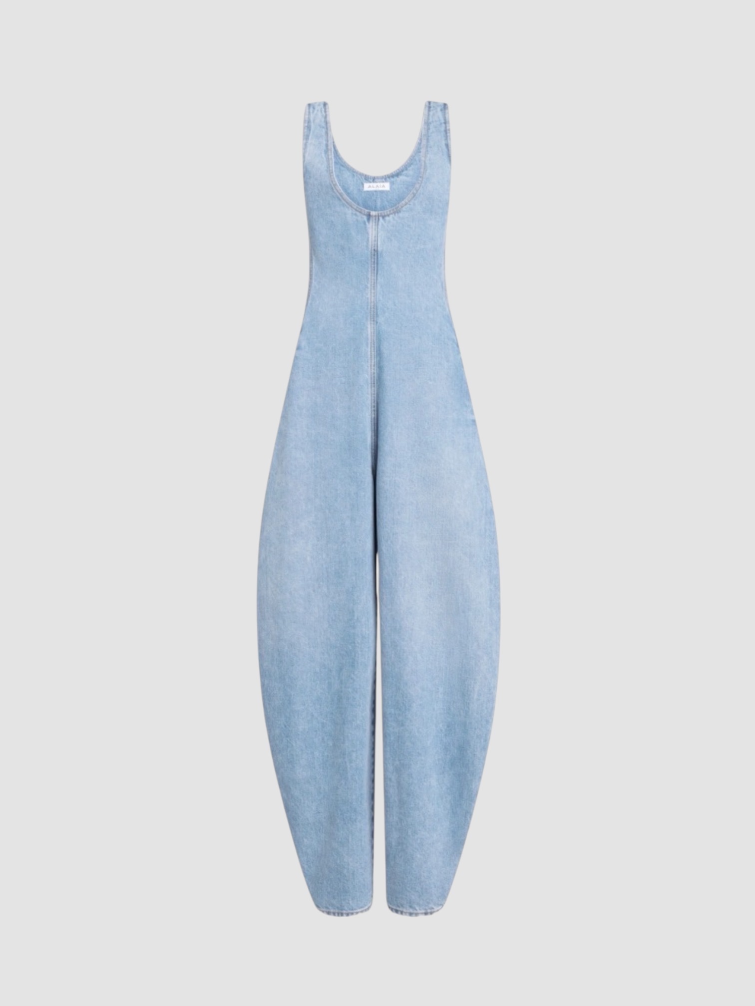 Alaïa Denim Jumpsuit in indigo, worn with Alaïa Torsion Leather Belt, Phoebe Philo Cruise Sunglasses, CO Ankle Wrap Sandal. Styled by Sharon Lombardo for FDV Concierge.
