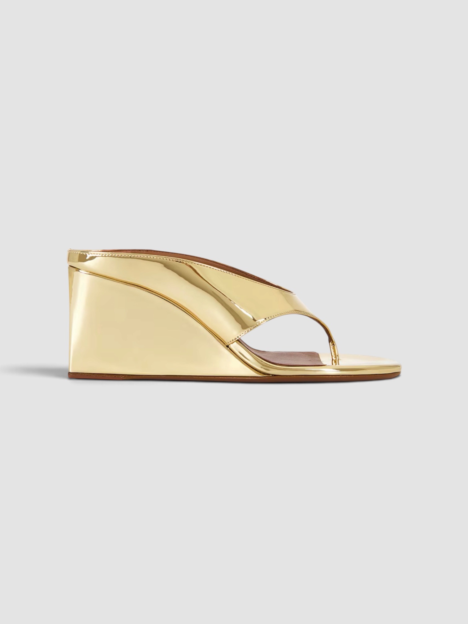 Alaïa Wedge Thong Mule in gold, worn with Alaïa Cropped Jersey Turtleneck Tee, Alaïa Balloon Pants. Styled by Sharon Lombardo for FDV Concierge.