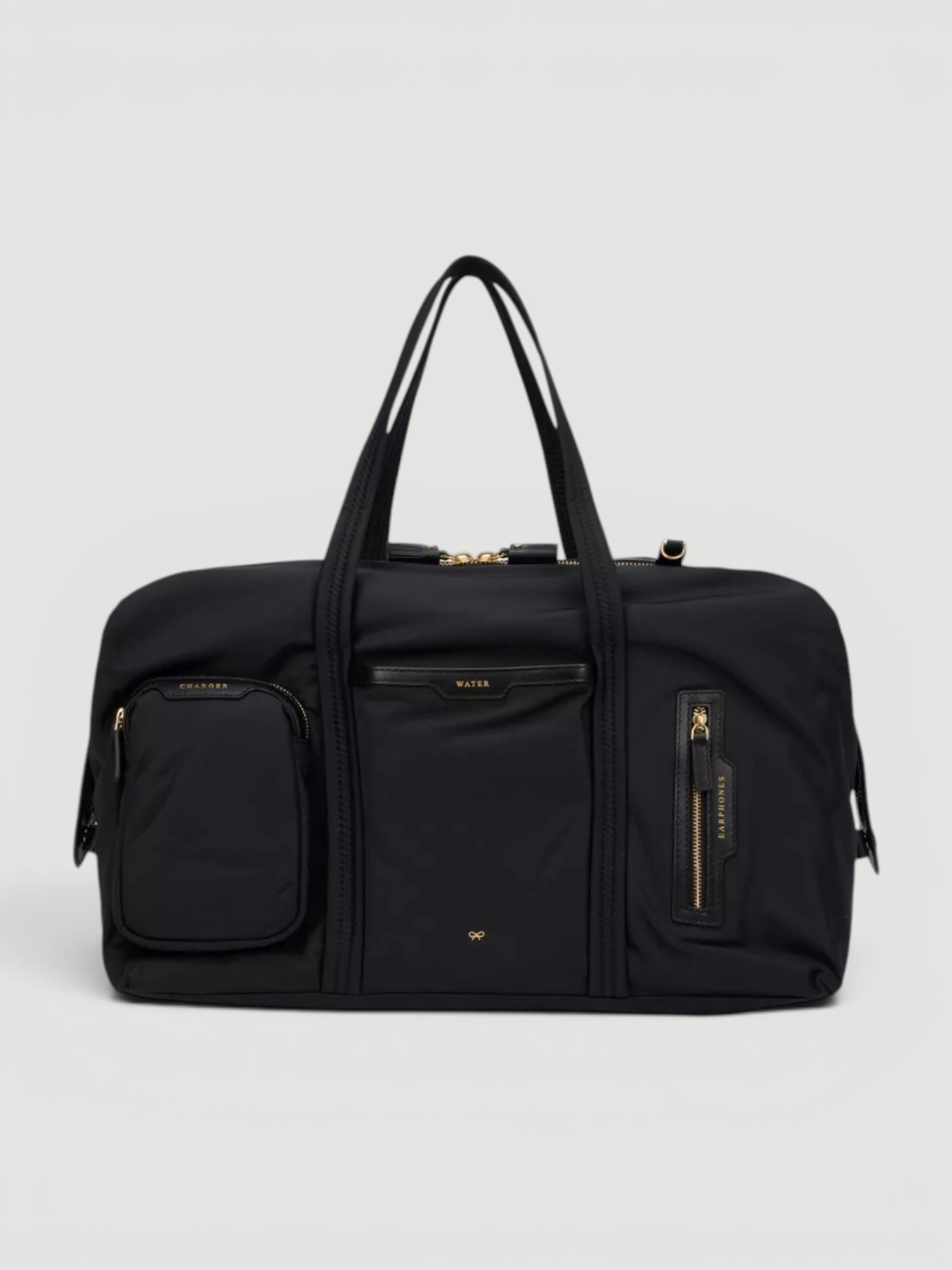 Anya Hindmarch In-Flight Shell Travel Bag in black.