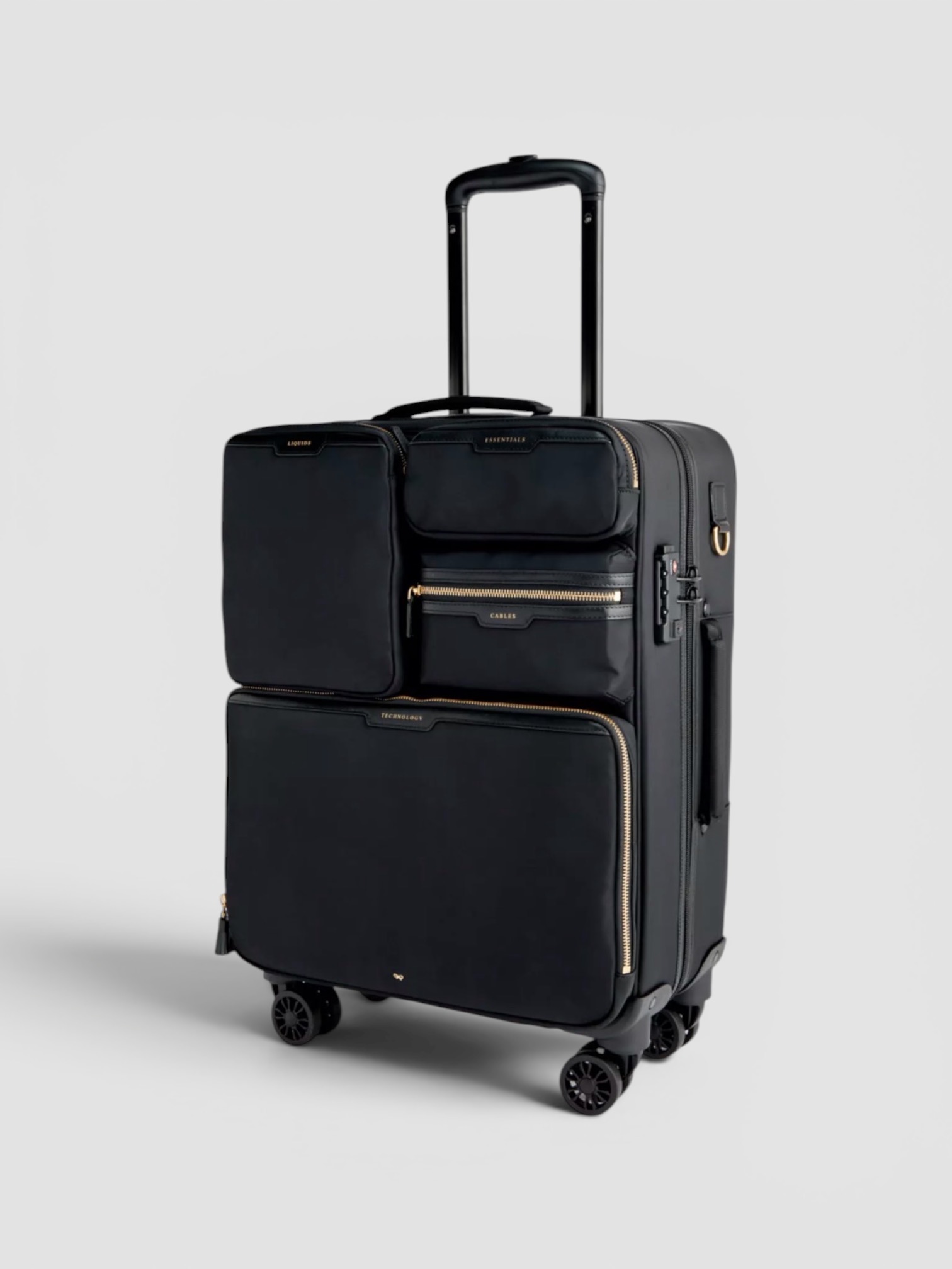 Anya Hindmarch Short-Haul Four-Wheel Nylon Luggage Case in black.