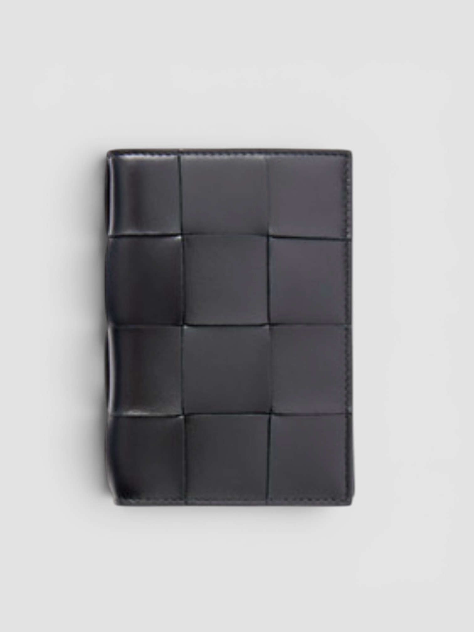 Bottega Veneta Cassette Intrecciato Passport Case in black.