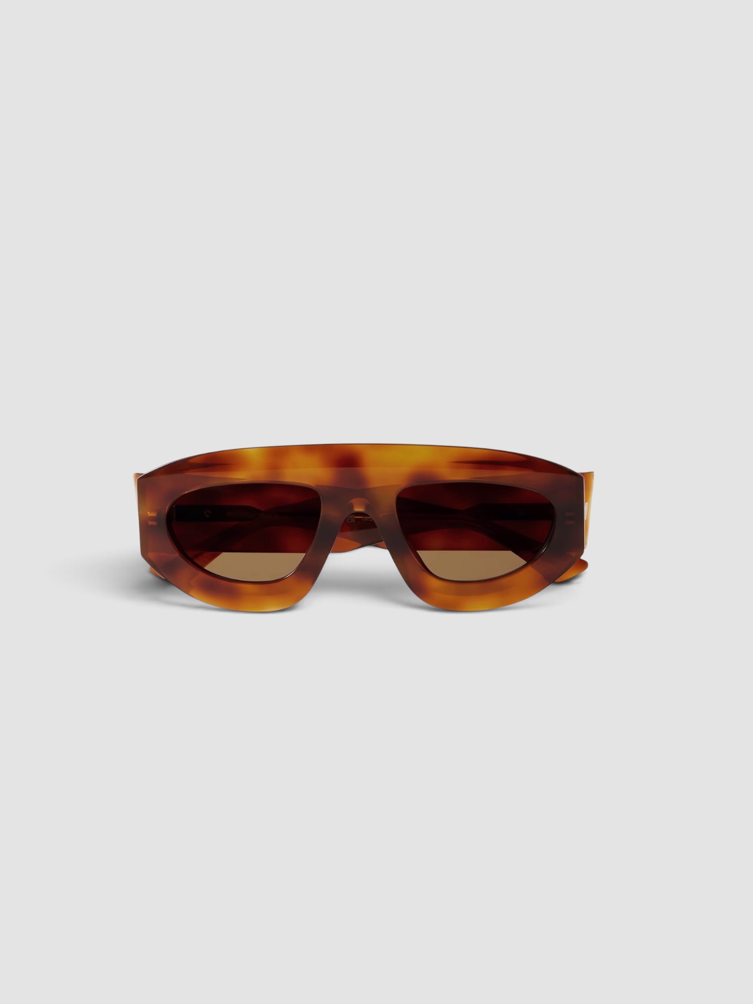 Bottega Veneta Aviator-Style Tortoiseshell Acetate Sunglasses in tortoiseshell, worn with Dries Van Noten Printed Twill Shirt, Dries Van Noten Printed Ruffled Midi Skirt, Bottega Veneta Sampieri Flat Thong, Bottega Veneta Loop Leather-Trimmed Raffia Tote Bag, the day. Styled by Sharon Lombardo for FDV Concierge.
