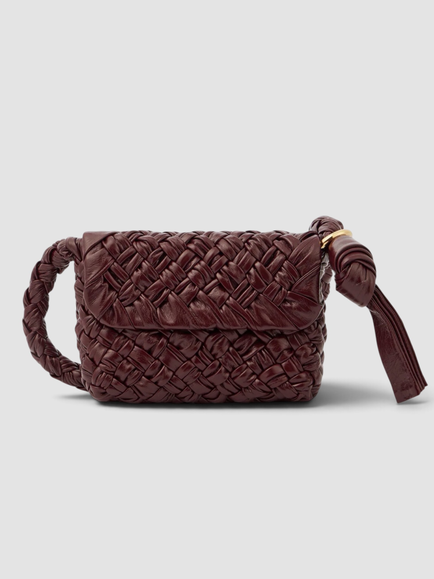 Bottega Veneta Kalimero Città Small Leather Shoulder Bag in burgundy, worn with BODE Feather Runner Embroidered Cotton-Blend Twill Jacket, BODE Feather Runner Embroidered Cotton-Blend Flared Pants, Dries Van Noten Oval Sunglasses, Bottega Veneta Sampieri Flat Thong, on the water. Styled by Sharon Lombardo for FDV Concierge.