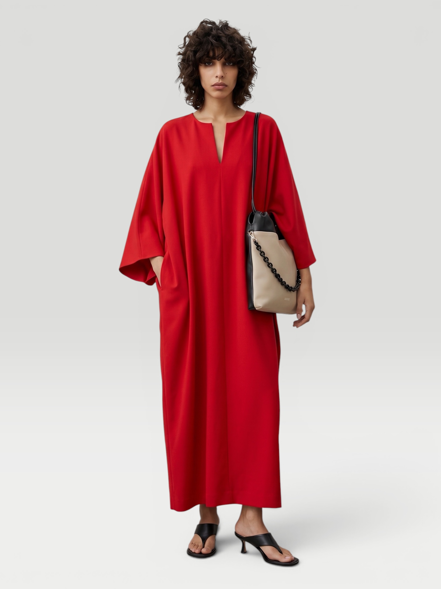 Bouguessa Nadia Kaftan in red, worn with Loewe Flamenco Two Tone Bag, Prada Patent Leather Thong Sandals. Styled by Sharon Lombardo for FDV Concierge.