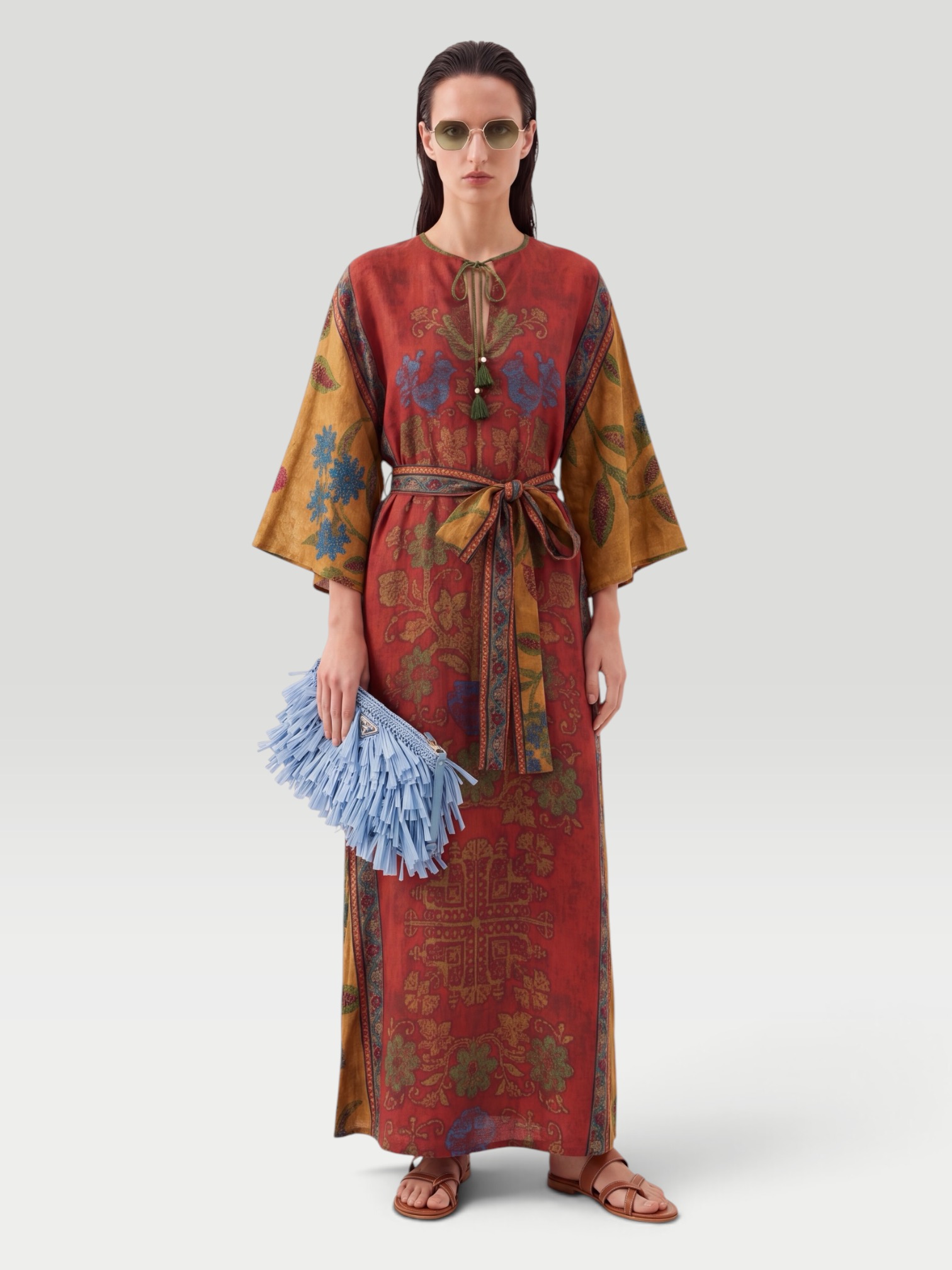 D'Ascoli Carpathia Silk Twill Belted Kaftan in red multi, worn with Prada Blue Fringed Clutch, Manolo Blahnik Susacru Leather Sandals, Dries Van Noten Oval Sunglasses, Phoebe Philo Gold Studded Hoops, walking the city. Styled by Sharon Lombardo for FDV Concierge.