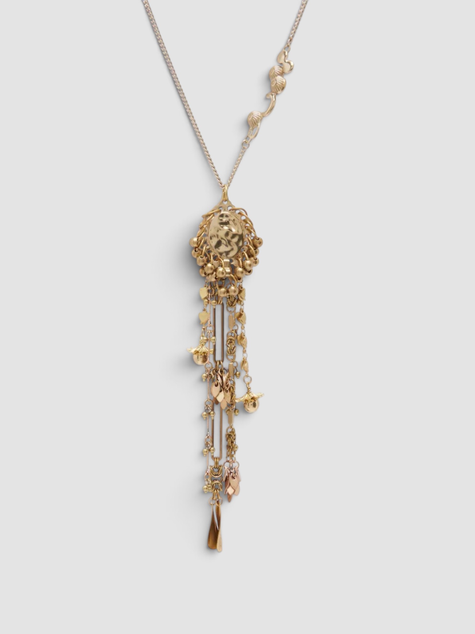 Dries Van Noten Embellished Pendant Necklace in gold, worn with Éliou For FWRD Baia Romper, Phoebe Philo Peak Sunglasses, Dries Van Noten Embellished Hoop Earrings, Phoebe Philo Frizz Flip Flop. Styled by Sharon Lombardo for FDV Concierge.