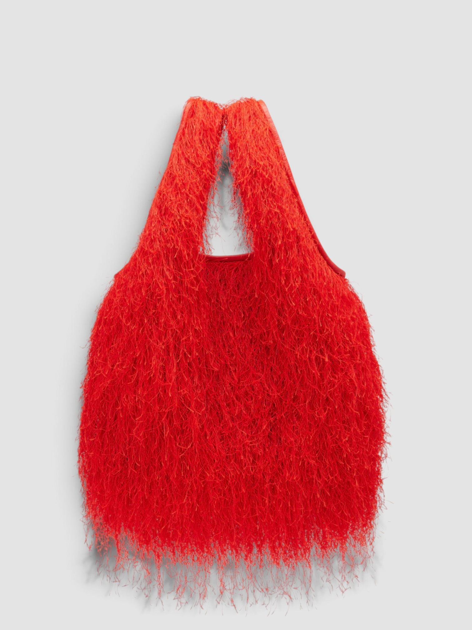 Dries Van Noten Marche Medium Fringed Top-Handle Bag in red, worn with Dries Van Noten Ruffled Printed Asymmetric Georgette Camisole, Dries Van Noten Printed Wide-Leg Pants, Dries Van Noten Flat Sandal, ALAÏA Mask-Frame Acetate Sunglasses, the day. Styled by Sharon Lombardo for FDV Concierge.