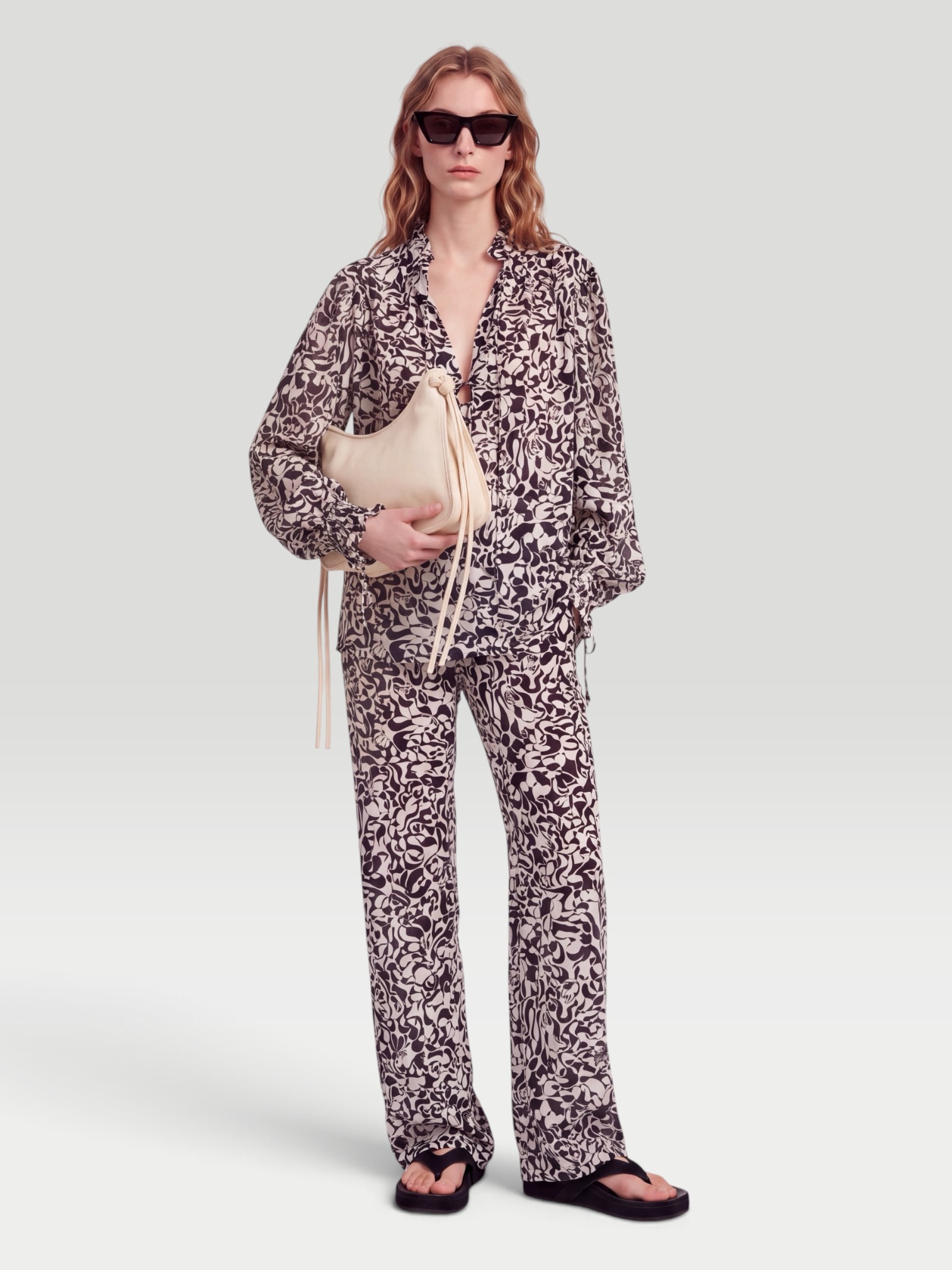 Dries Van Noten Printed Blouse in black/cream, worn with Dries Van Noten Printed Straight Pants, Phoebe Philo Frizz Flip Flop, Phoebe Philo Small Gig Leather Shoulder Bag, Phoebe Philo Peak Sunglasses, walking the city. Styled by Sharon Lombardo for FDV Concierge.
