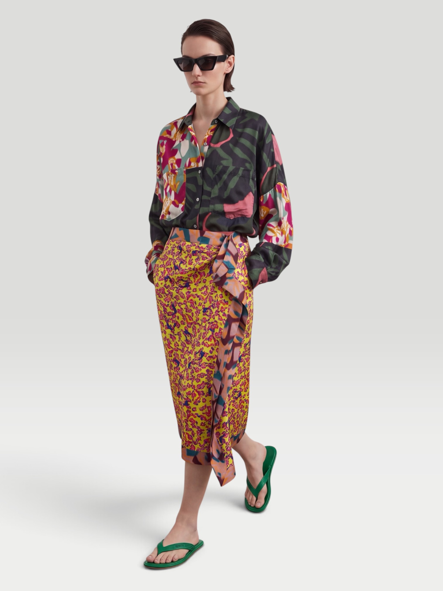 Dries Van Noten Printed Ruffled Midi Skirt in yellow, worn with Dries Van Noten Printed Twill Shirt, Bottega Veneta Sampieri Flat Thong, Bottega Veneta Aviator-Style Tortoiseshell Acetate Sunglasses, Bottega Veneta Loop Leather-Trimmed Raffia Tote Bag, the day. Styled by Sharon Lombardo for FDV Concierge.