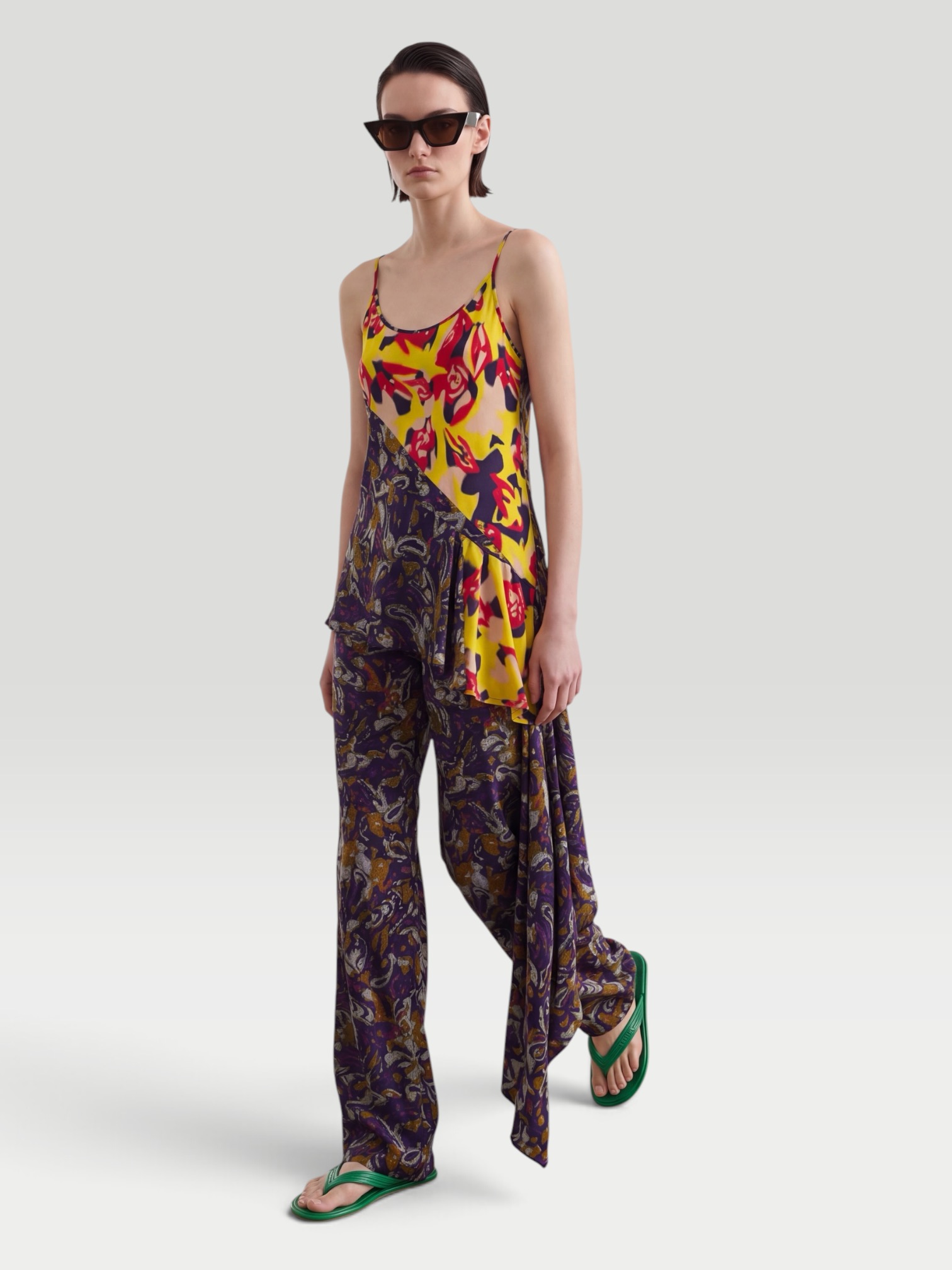 Dries Van Noten Printed Wide-Leg Pants in purple, worn with Dries Van Noten Ruffled Printed Asymmetric Georgette Camisole, Dries Van Noten Flat Sandal, Dries Van Noten Marche Medium Fringed Top-Handle Bag, ALAÏA Mask-Frame Acetate Sunglasses, the day. Styled by Sharon Lombardo for FDV Concierge.