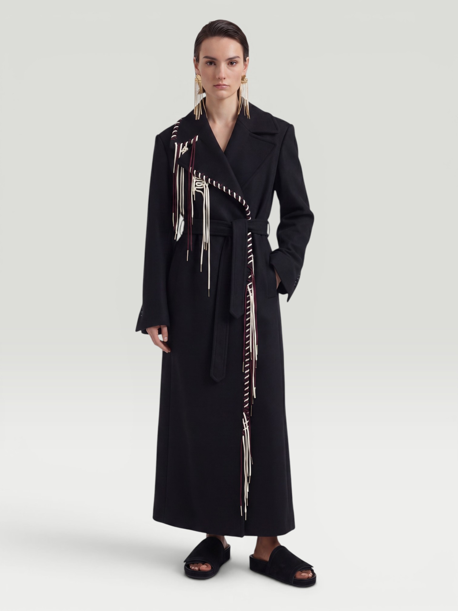 Dries Van Noten Rafaella Coat in black, worn with Jil Sander Fringed Hoop Earrings, Phoebe Philo Suede Slides. Styled by Sharon Lombardo for FDV Concierge.