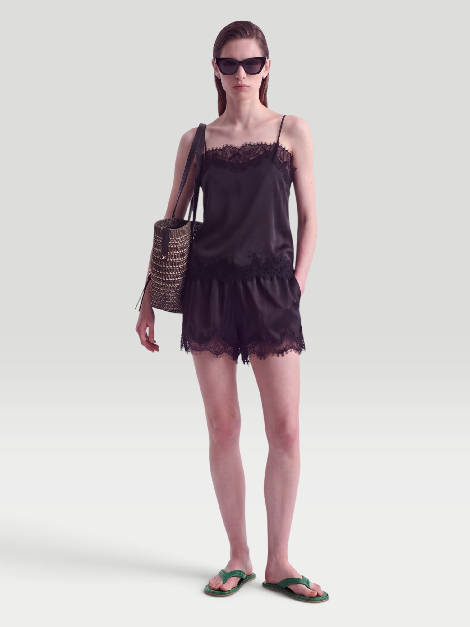 Faithfull Marisol Lace-Trimmed Satin Shorts in black, worn with Bottega Veneta Sampieri Flat Thong. Styled by Sharon Lombardo for FDV Concierge.