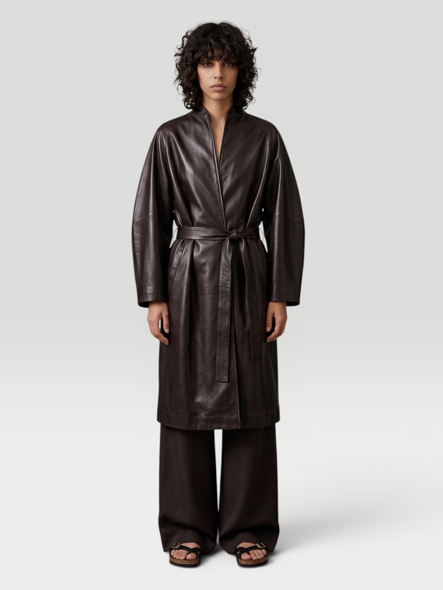 Fear Of God Women's Leather Coat in espresso, worn with Jil Sander Envers Satin Trousers, Birkenstock Mayari. Styled by Sharon Lombardo for FDV Concierge.