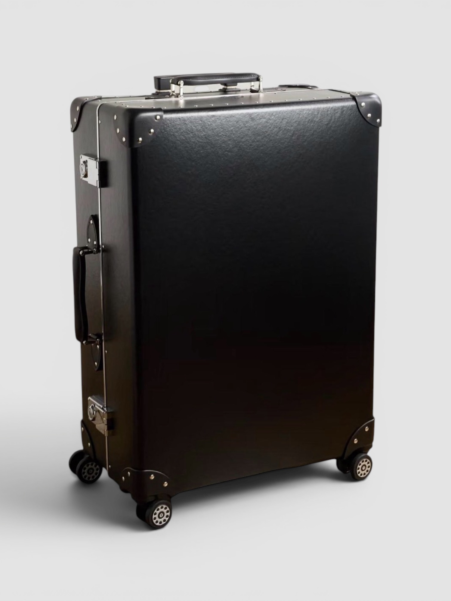 Globe-Trotter Metropolis Leather-Trimmed Suitcase in black.