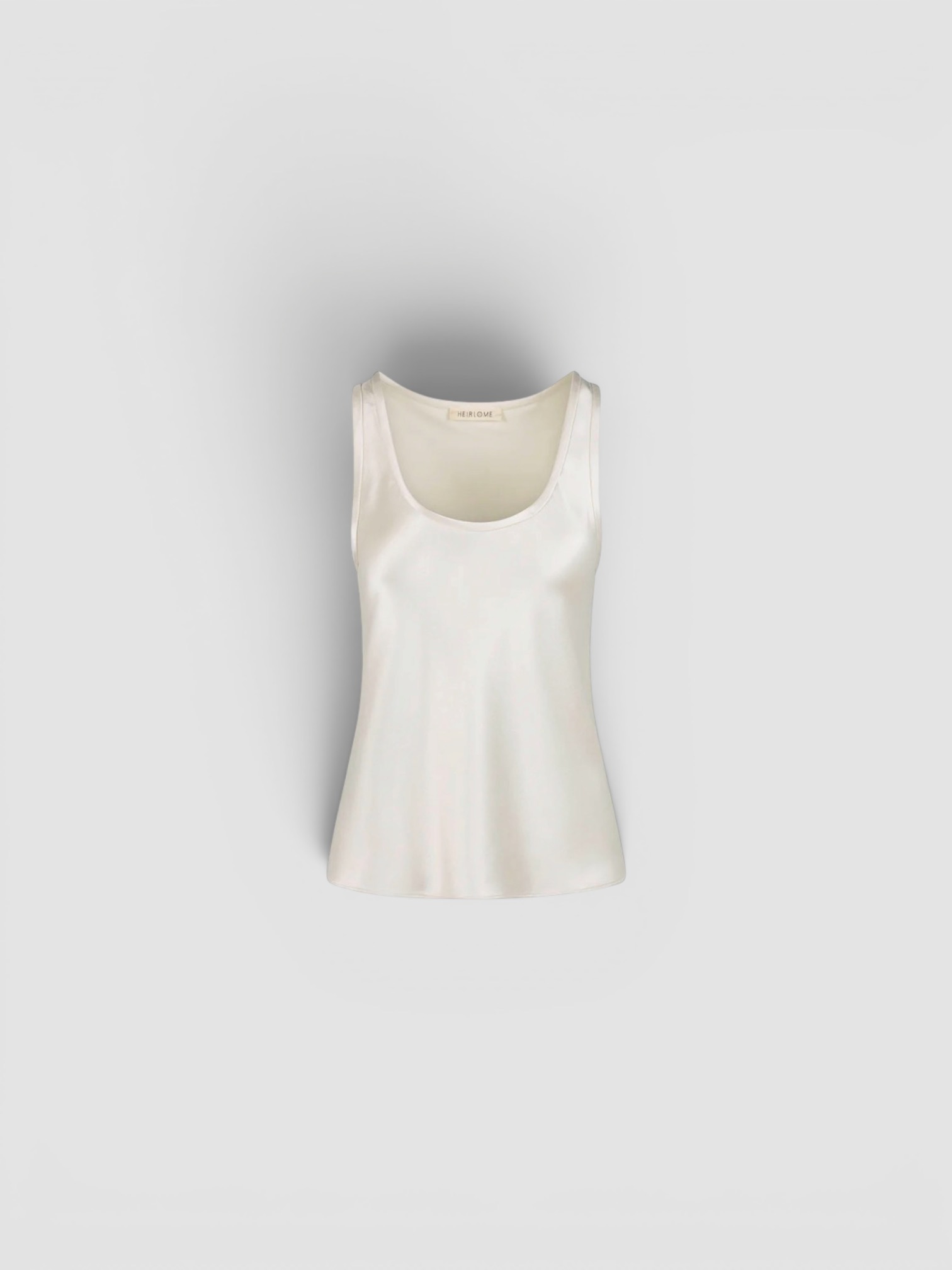 Heirlome Adau Top in ivory, worn with Khaite Walter Cotton and Silk-Blend Flared Pants. Styled by Sharon Lombardo for FDV Concierge.