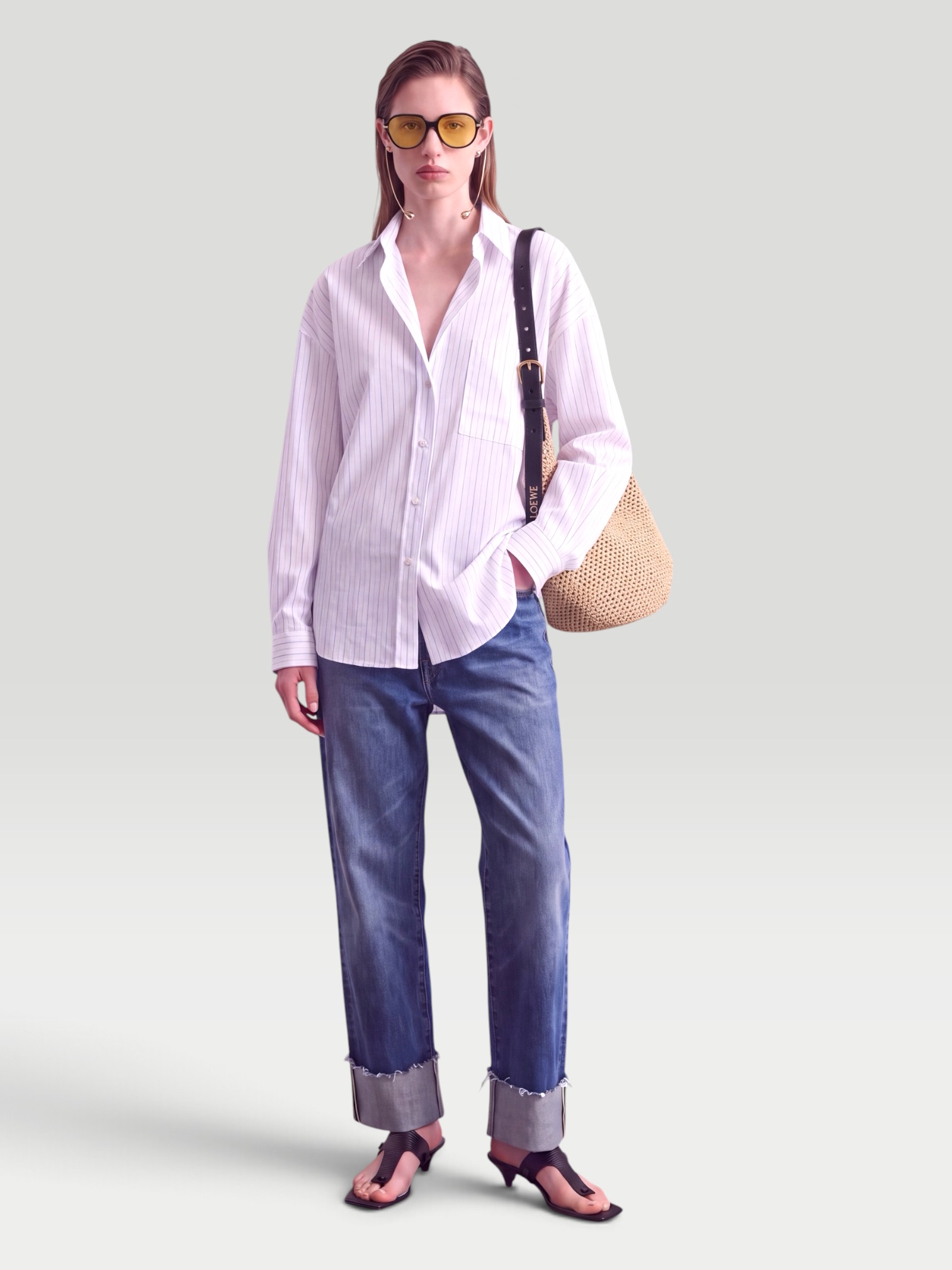 Jacquemus Cuadro Asymmetric Striped Cotton Shirt in white, worn with R13 Cuffed X-Boyfriend Jeans, Bottega Veneta Drop Squared Sunglasses. Styled by Sharon Lombardo for FDV Concierge.