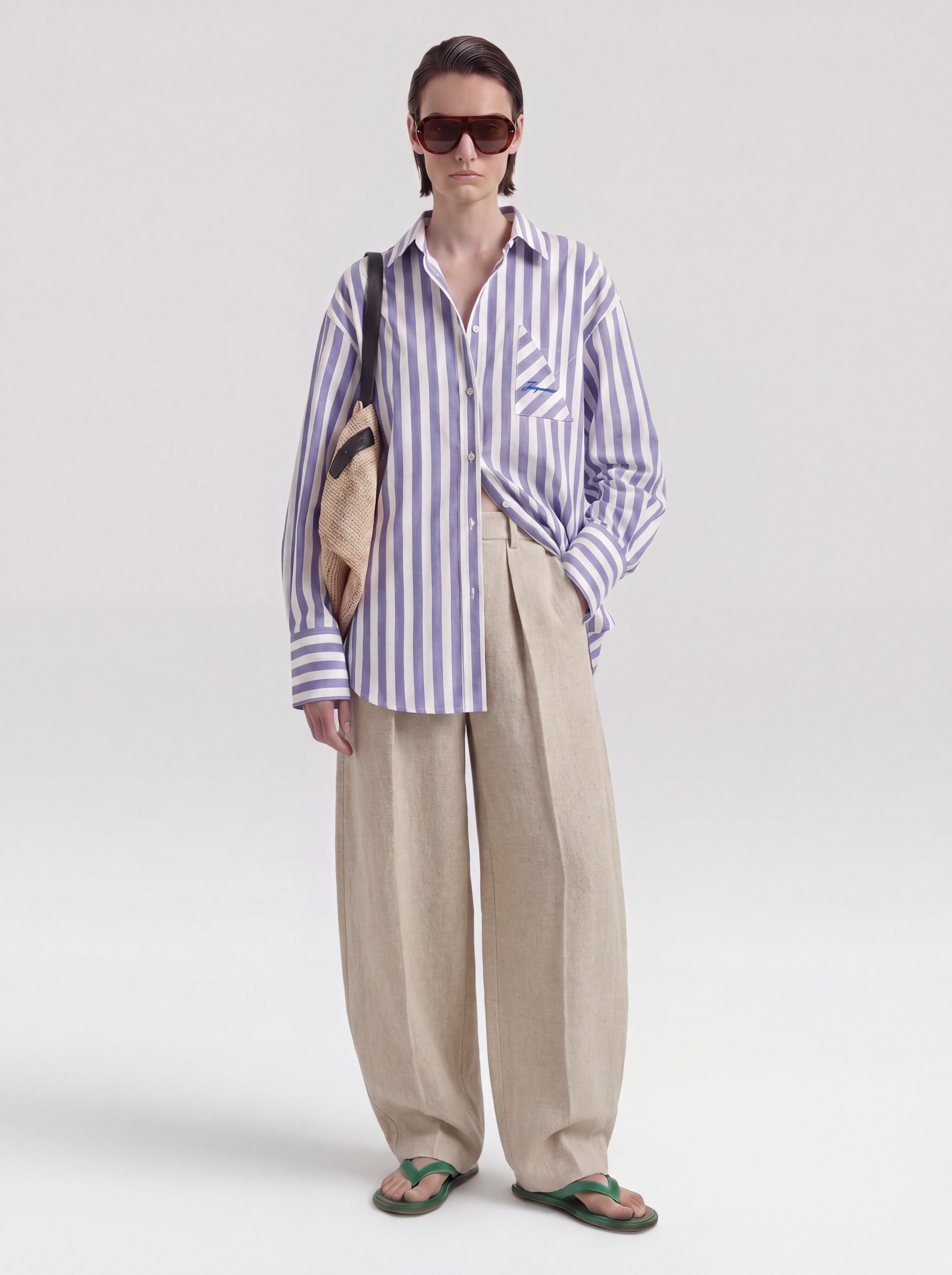 Jacquemus Striped Shirt in blue, worn with Jacquemus Le Marin High Rise Shorts, Bottega Veneta Small Onda Clutch, Neous Arneb 65 Sandals. Styled by Sharon Lombardo for FDV Concierge.
