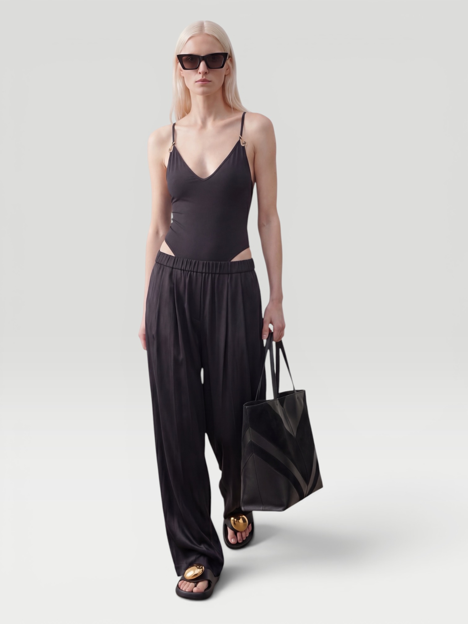 Jil Sander Envers Satin Trousers in black, worn with Jil Sander Long-Sleeved Collared Shirt, Phoebe Philo Pot Cabas Suede and Leather Tote Bag, Loewe Toggle Flat Sandal. Styled by Sharon Lombardo for FDV Concierge.