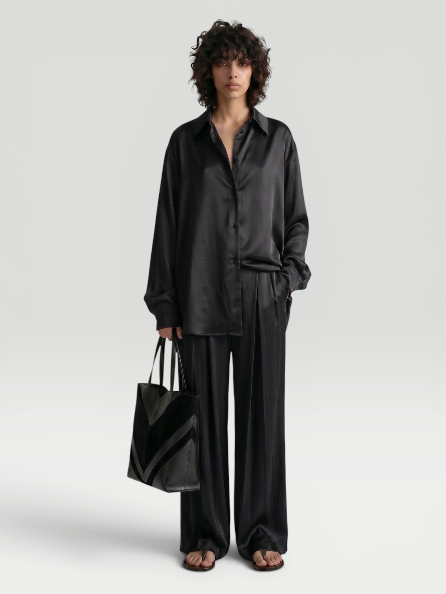 Jil Sander Long-Sleeved Collared Shirt in black, worn with Jil Sander Envers Satin Trousers, Phoebe Philo Pot Cabas Suede and Leather Tote Bag, Loewe Toggle Flat Sandal. Styled by Sharon Lombardo for FDV Concierge.