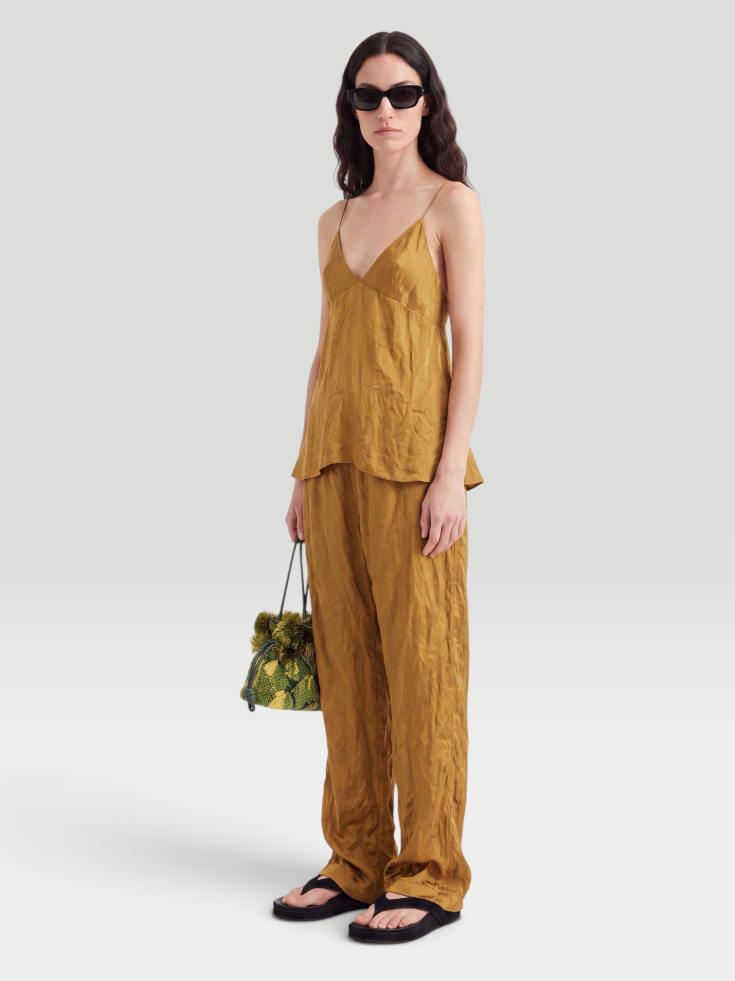Khaite Rohen Crinkled-Voile Pants in gold. Styled by Sharon Lombardo for FDV Concierge.