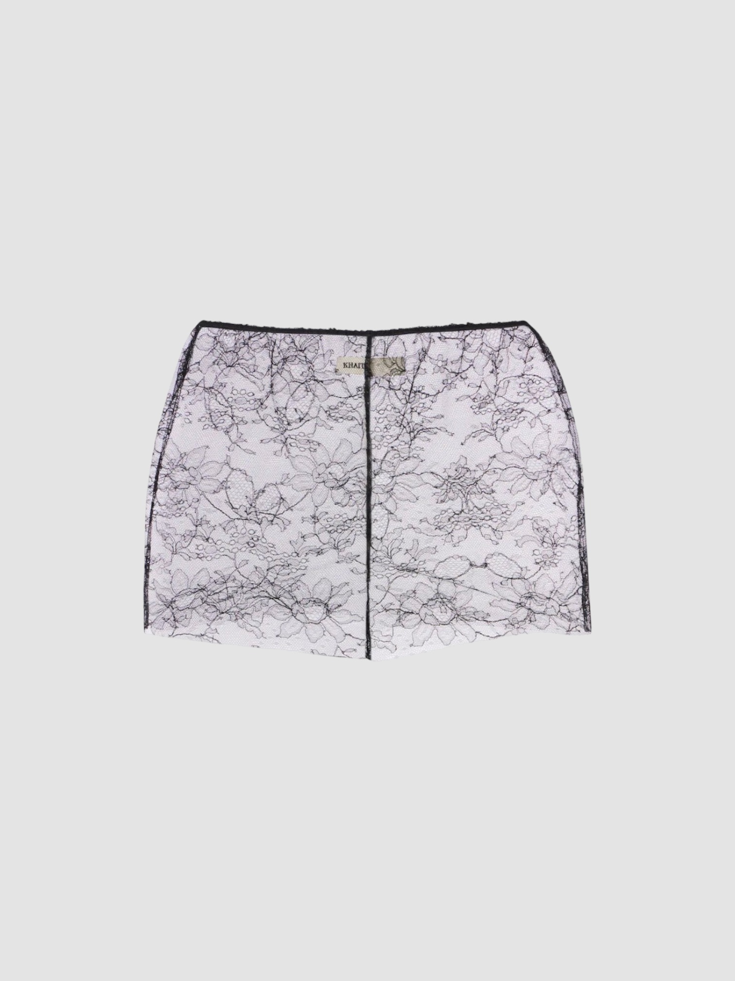 Khaite Tilly Sheer Lace Shorts in black.