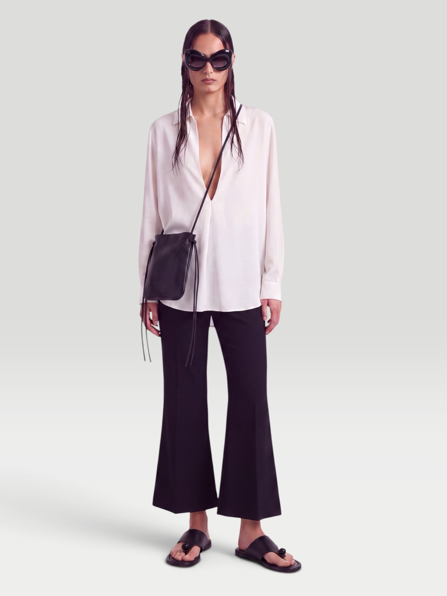 Khaite Walter Cotton and Silk-Blend Flared Pants in black, worn with Heirlome Adau Top. Styled by Sharon Lombardo for FDV Concierge.