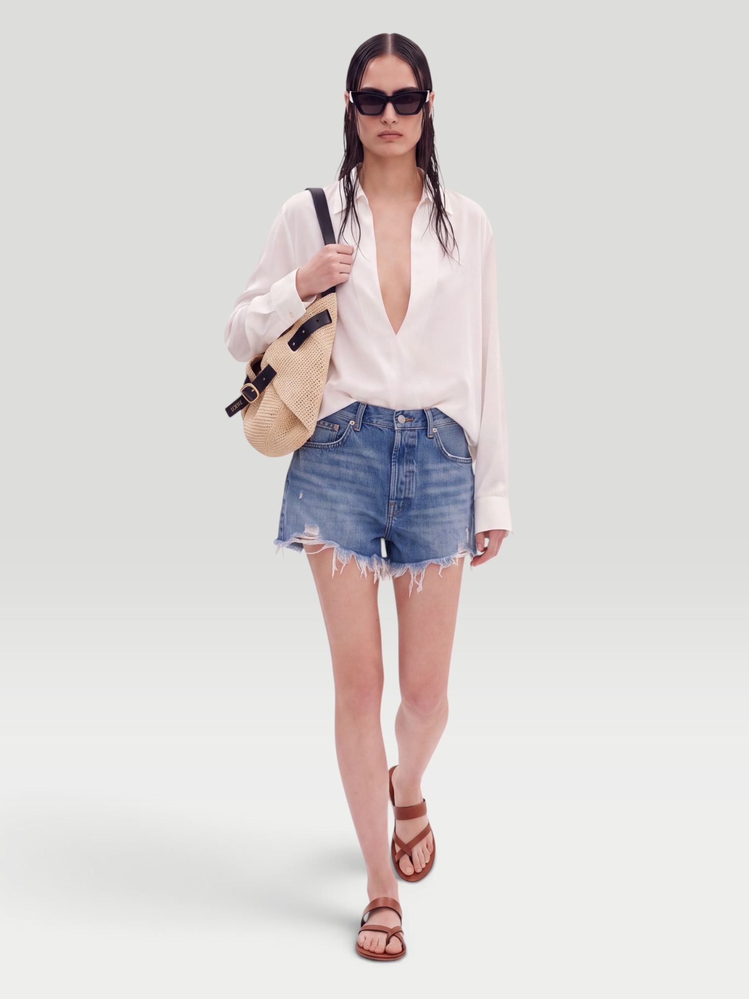 Levi's 501 Original Short in athens mid, worn with SSSTEIN Skipper Cotton Shirt, Manolo Blahnik Susacru Leather Sandals, Loewe Leather-Trimmed Raffia Tote, Loewe Inflated Cat Eye Sunglasses, walking the city. Styled by Sharon Lombardo for FDV Concierge.