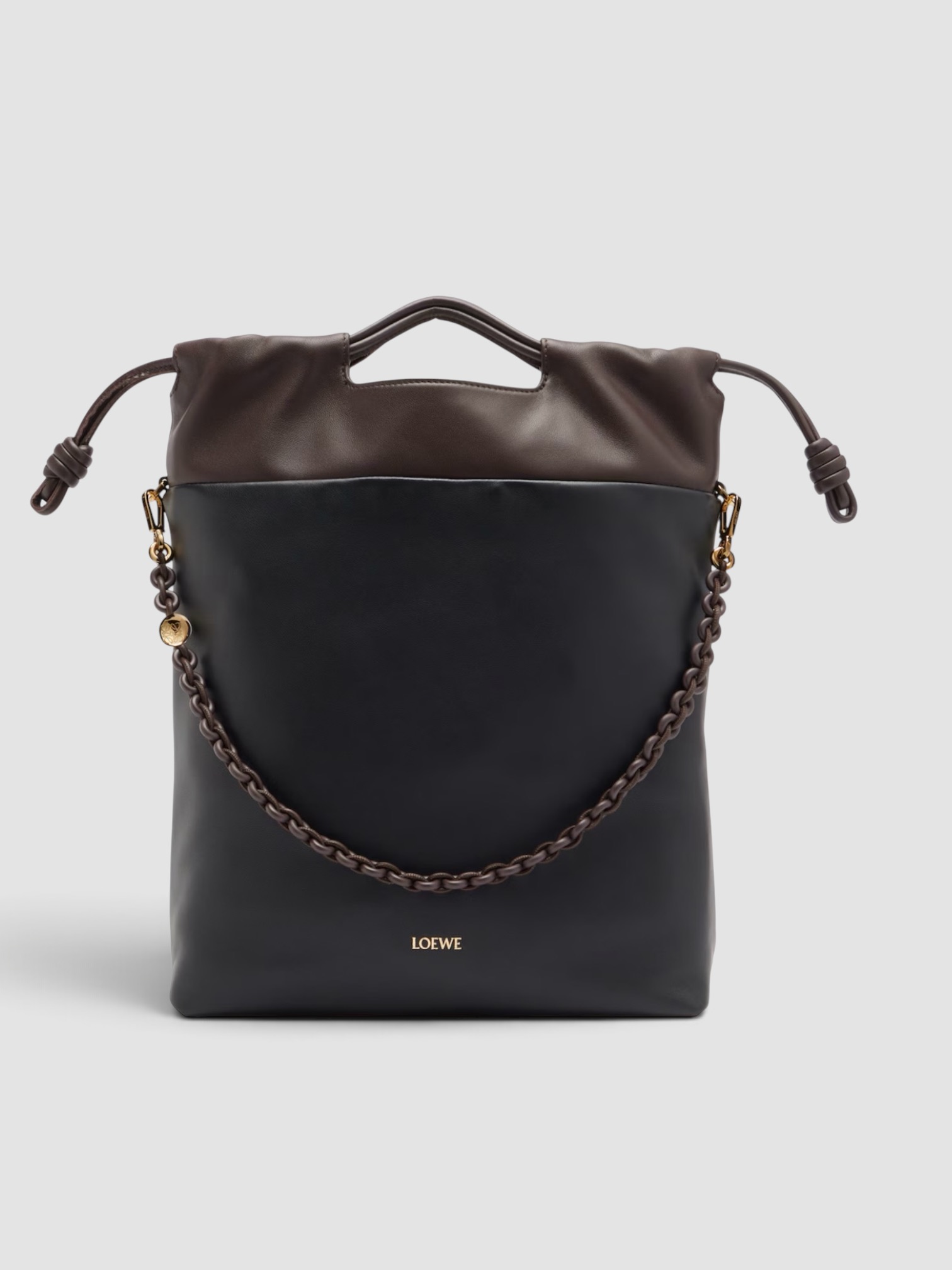 Loewe Flamenco Leather Clutch in brown, worn with Totême Striped Shirtdress. Styled by Sharon Lombardo for FDV Concierge.