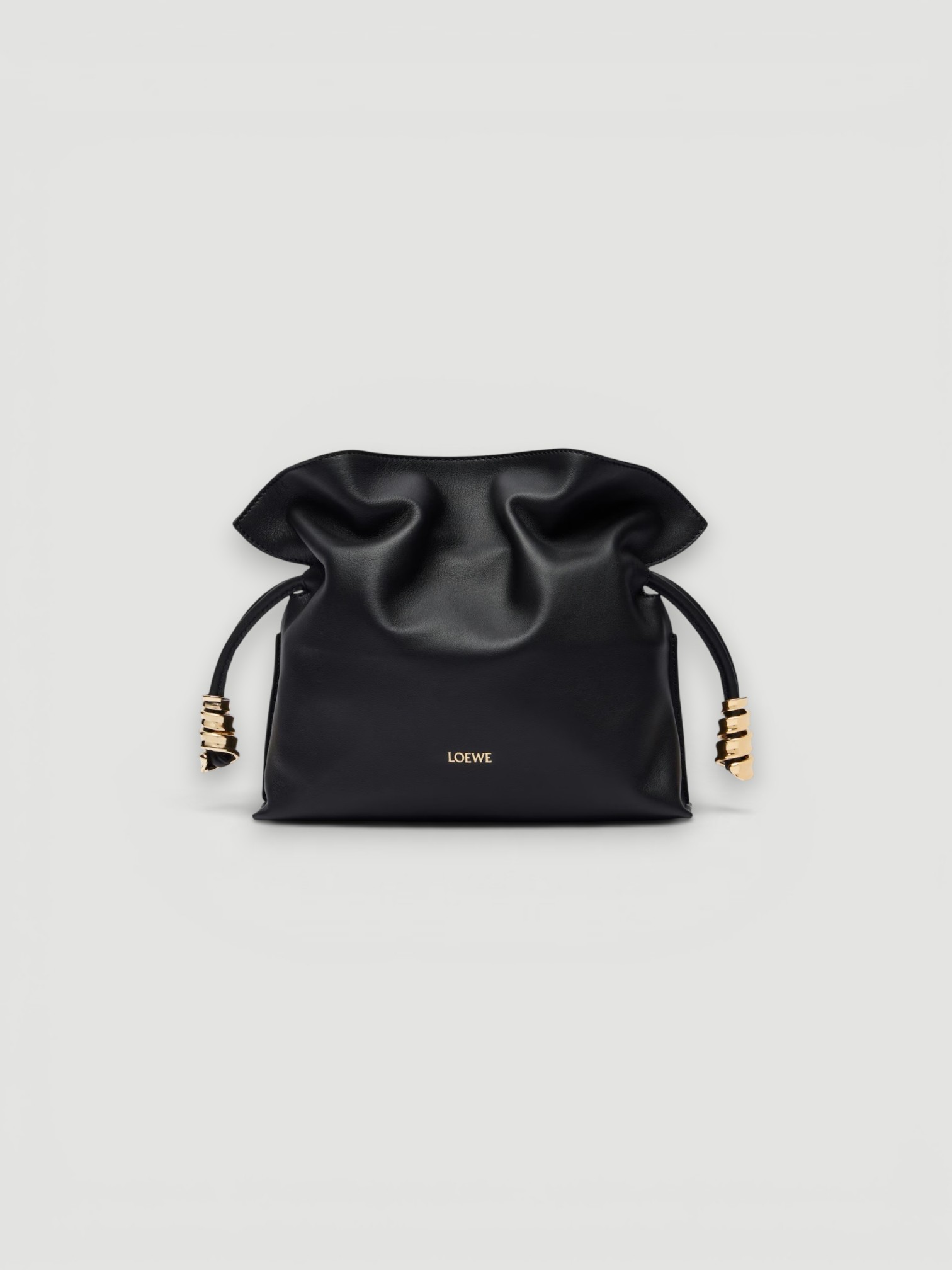 Loewe Flamenco Coil Mini Leather Clutch in black, worn with FIL DE VIE Isadora Dress. Styled by Sharon Lombardo for FDV Concierge.
