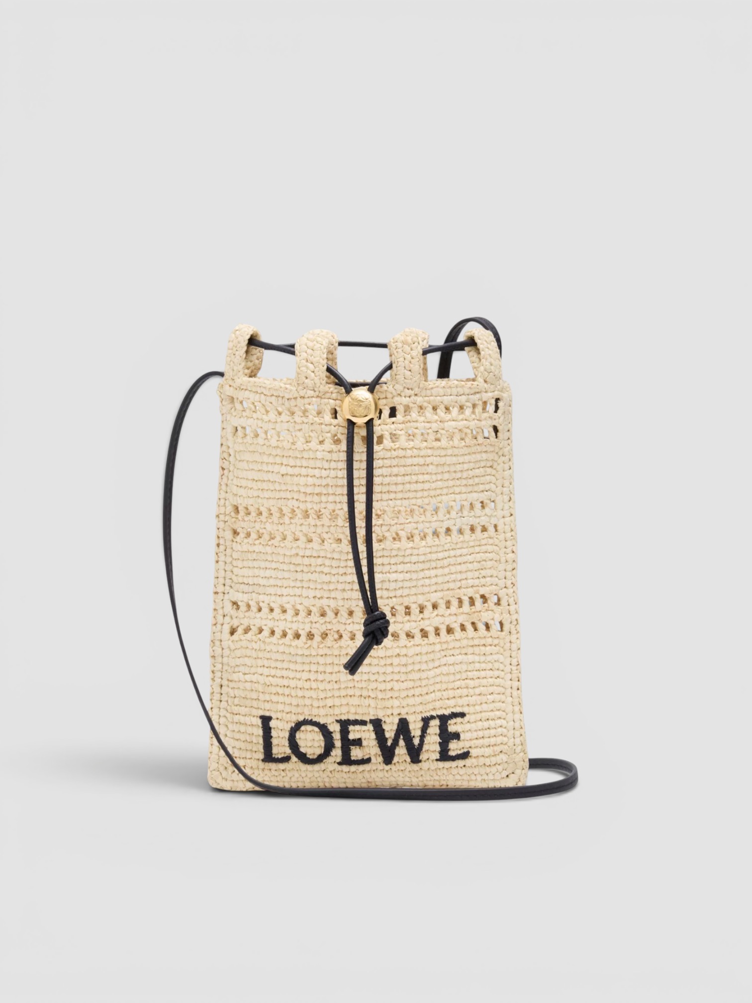 Loewe Paula's Ibiza Drawstring Pocket Raffia Cross-Body Bag in natural, worn with Totême Striped Shirtdress. Styled by Sharon Lombardo for FDV Concierge.