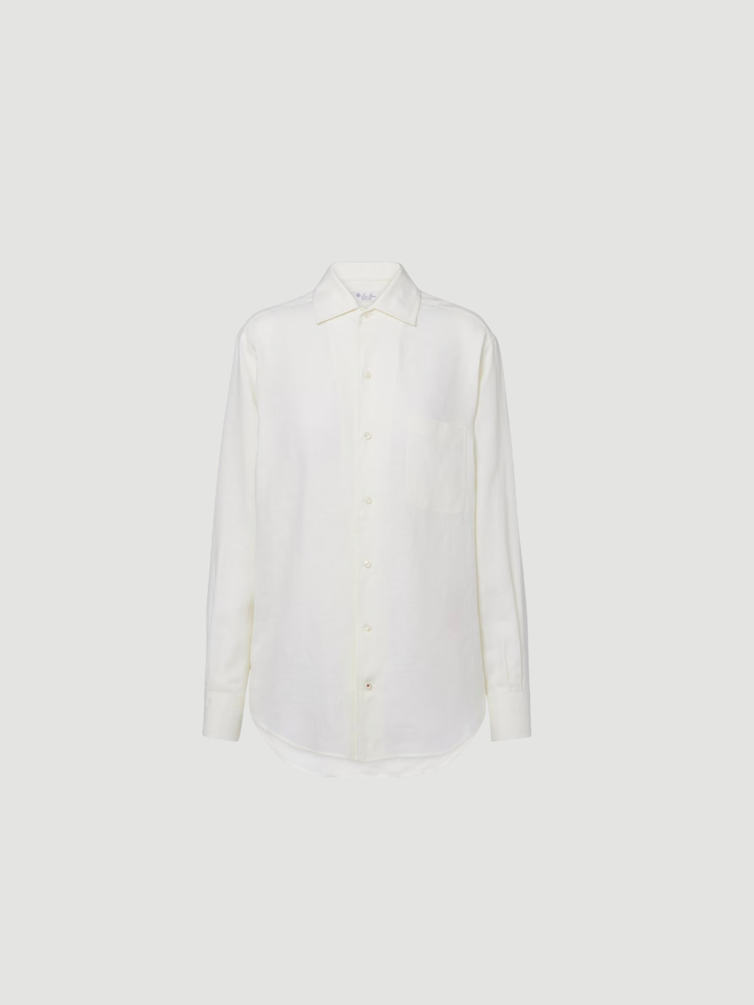 Loro Piana Andre Linen Shirt in white, worn with Coperni One-Shoulder Logo-Plaque Swimsuit, Bottega Veneta Sampieri Flat Thong, Arhaus Rivi Beach Towel, Loewe Leather-Trimmed Raffia Tote, on the water. Styled by Sharon Lombardo for FDV Concierge.