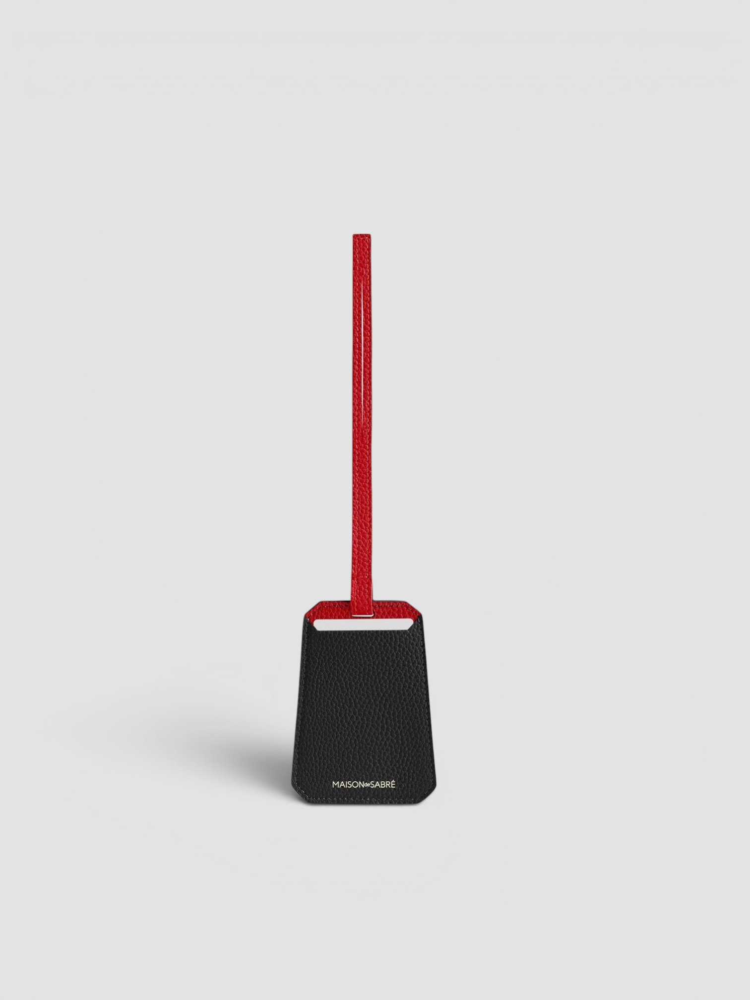 Maison de Sabré The Luggage Tag in black with red.