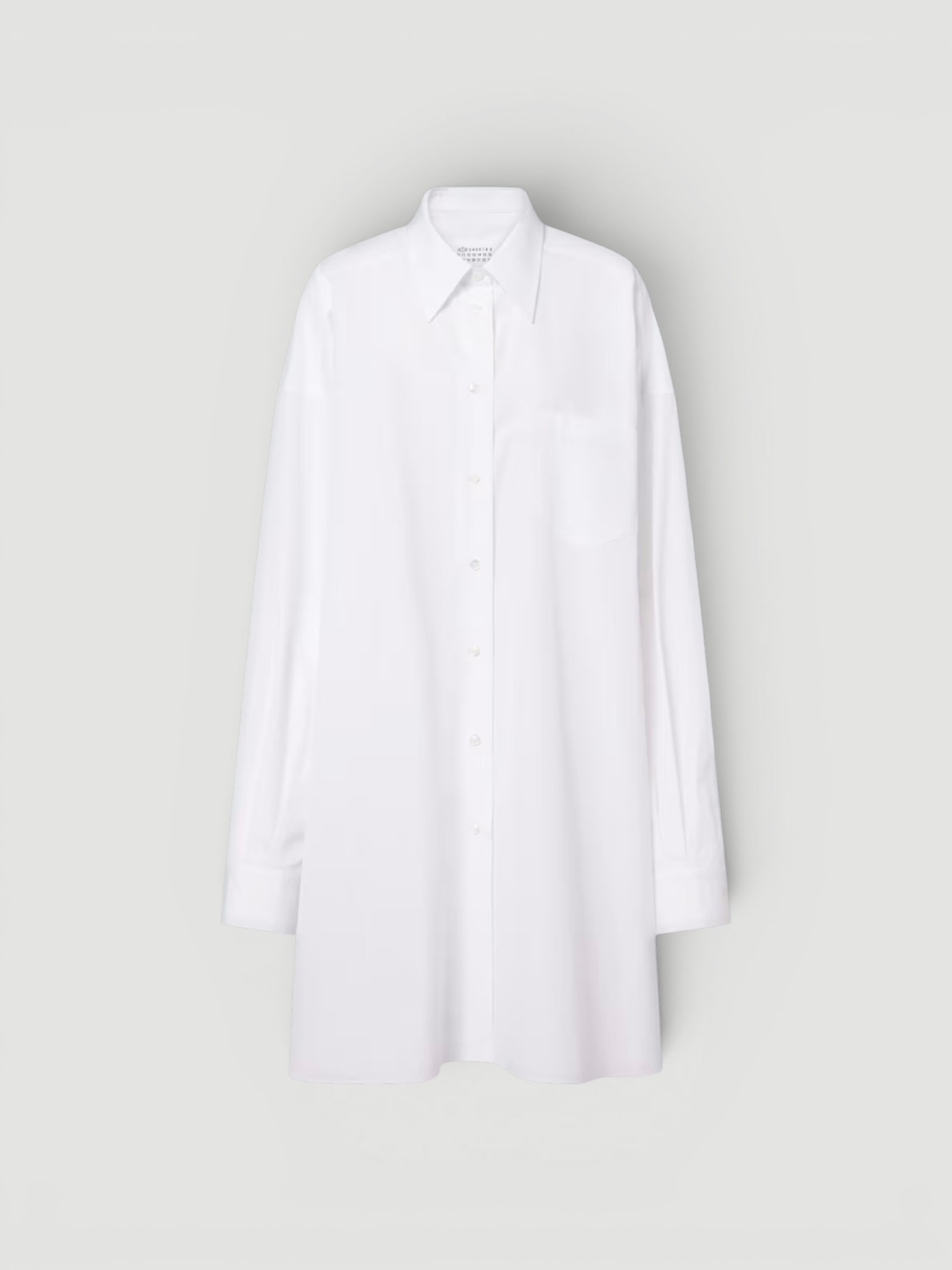 Maison Margiela Oversized Cotton Poplin Shirt in white, worn with Saint Jane Sun-Kissed Ritual Set, Curlsmith Defrizzion Travel Hair Dryer & Diffuser, the day. Styled by Sharon Lombardo for FDV Concierge.