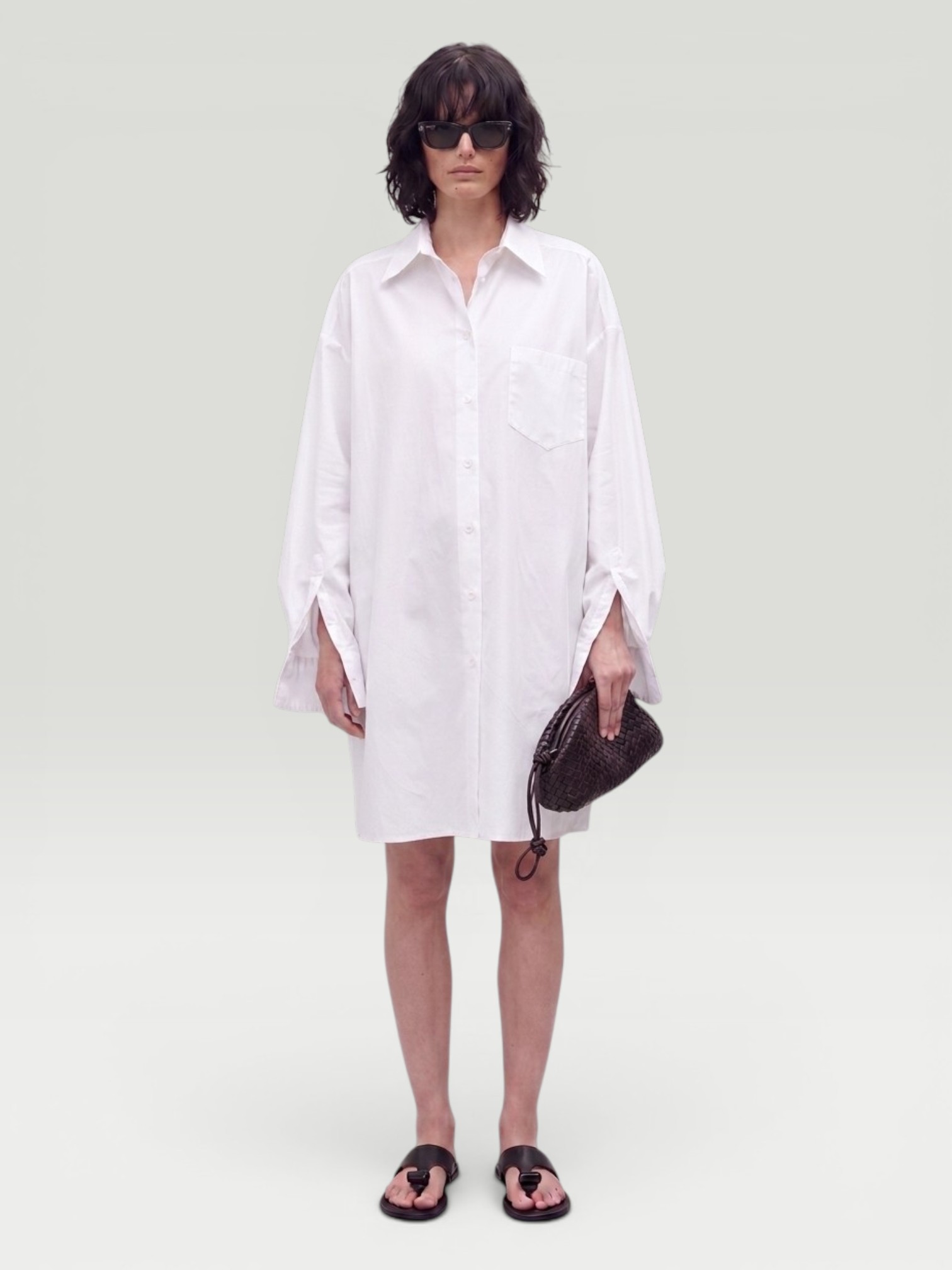 Maison Margiela Oversized Cotton Poplin Shirt in white, worn with Saint Jane Sun-Kissed Ritual Set, Curlsmith Defrizzion Travel Hair Dryer & Diffuser, the day. Styled by Sharon Lombardo for FDV Concierge.