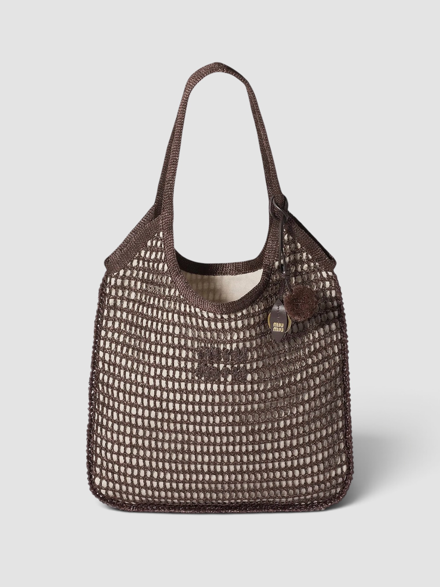 Miu Miu Ivy Raffia Crochet Shoulder Bag in brown, worn with Totême Striped Shirtdress. Styled by Sharon Lombardo for FDV Concierge.