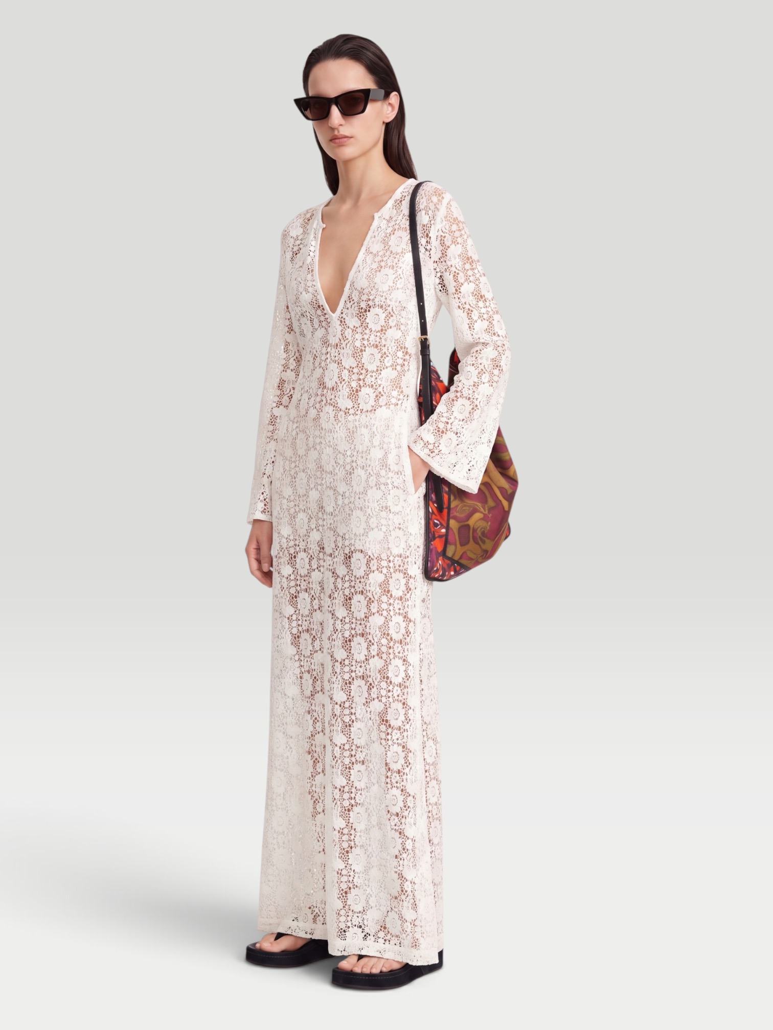 Nili Lotan Della Lace Maxi Dress in ivory, worn with Phoebe Philo Frizz Flip Flop, Phoebe Philo Small Stud Cabas Tote Bag, Phoebe Philo Gold Studded Hoops, Phoebe Philo Peak Sunglasses, walking the city. Styled by Sharon Lombardo for FDV Concierge.