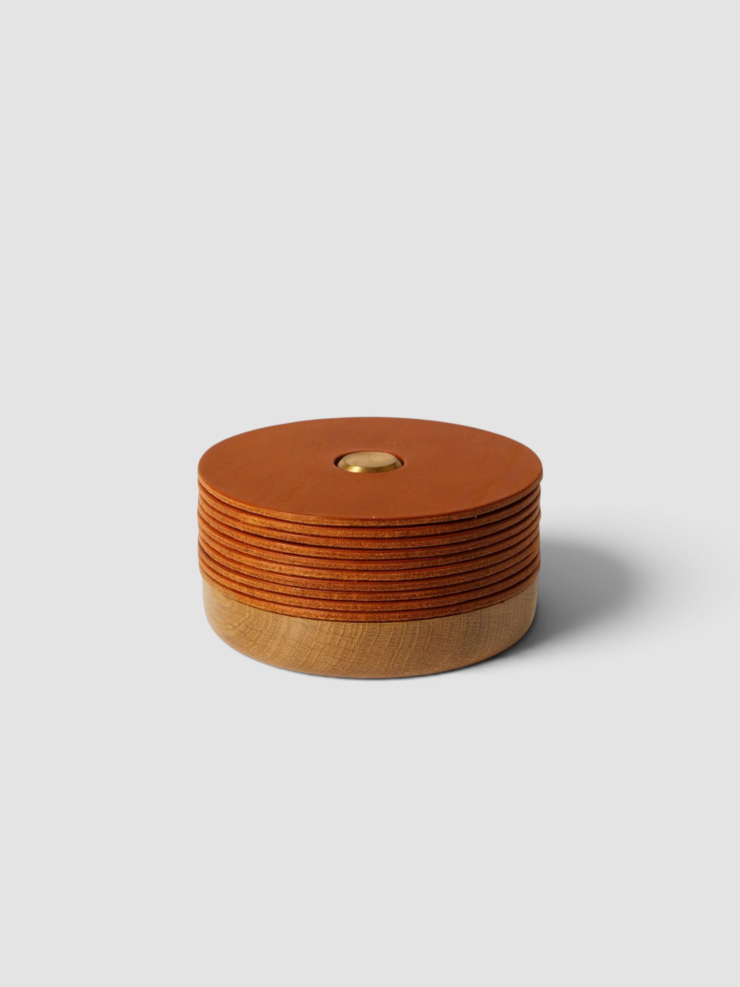 Otzi Studio Set of 10 Gasket Leather Coasters in tan.