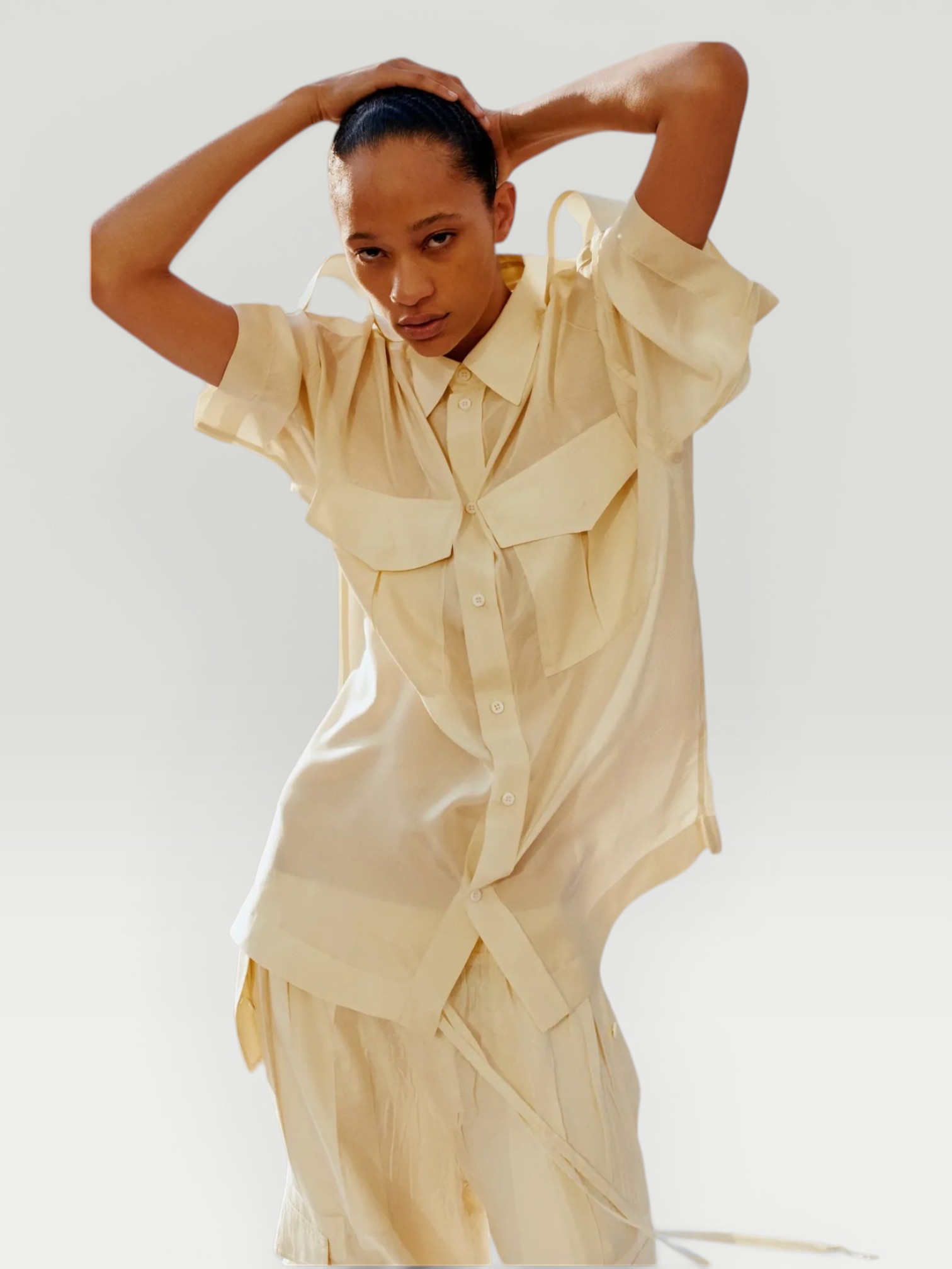 Phoebe Philo Silk Shirt in white, worn with Phoebe Philo Wide-Leg Jeans, Phoebe Philo Peak Sunglasses, Bottega Veneta Sampieri Flat Thong, Phoebe Philo Small Stud Cabas Tote Bag, on the water. Styled by Sharon Lombardo for FDV Concierge.