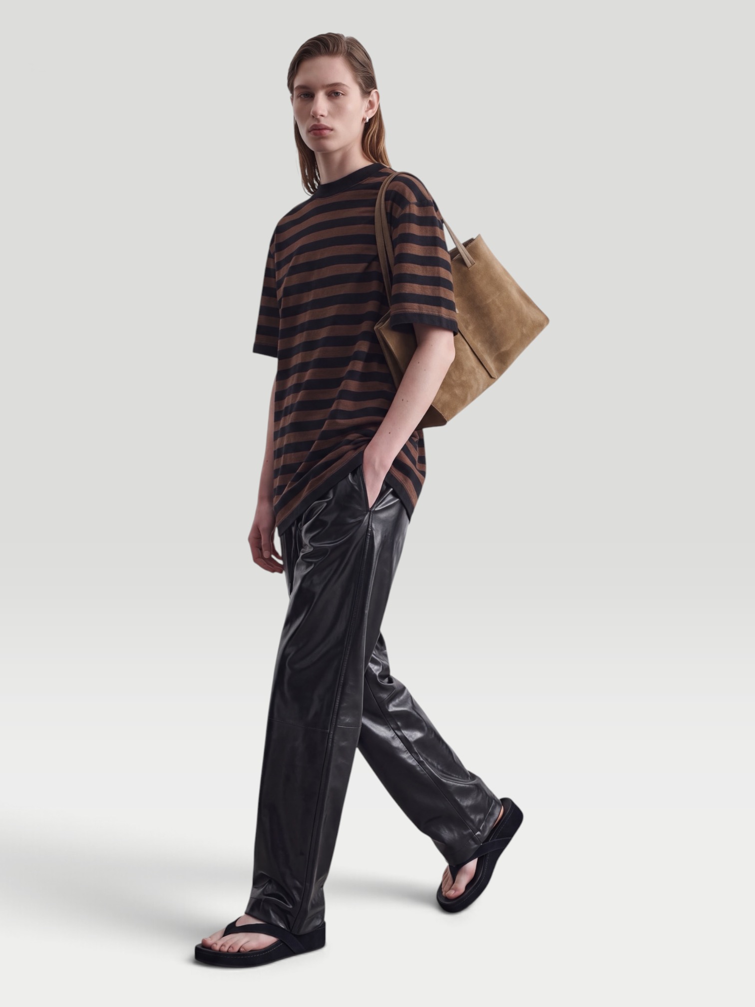 Phoebe Philo Leather Wide-Leg Pants in black, worn with Phoebe Philo Striped Cotton-Jersey T-Shirt. Styled by Sharon Lombardo for FDV Concierge.