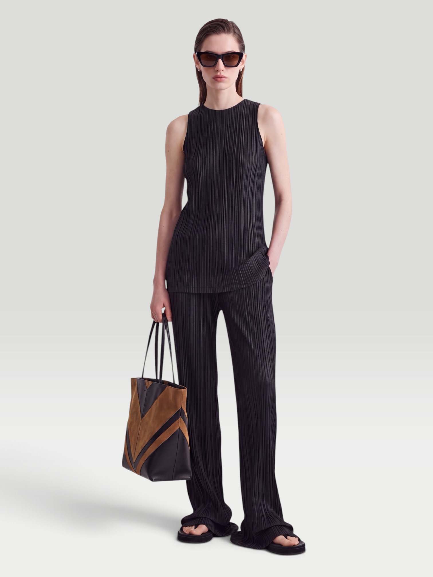 Phoebe Philo Razor Pleated Straight-Leg Pants in black, worn with Phoebe Philo Razor Pleated Tank. Styled by Sharon Lombardo for FDV Concierge.