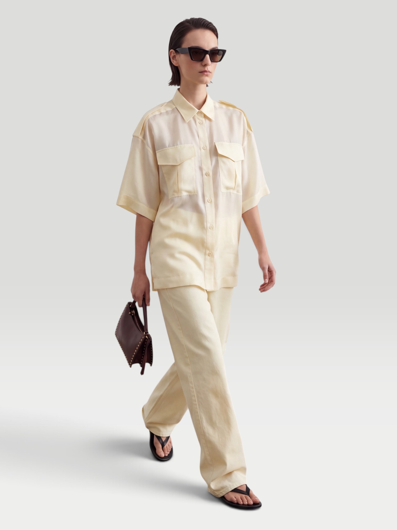 Phoebe Philo Wide-Leg Jeans in butter, worn with Phoebe Philo Silk Shirt, Phoebe Philo Peak Sunglasses, Bottega Veneta Sampieri Flat Thong, Phoebe Philo Small Stud Cabas Tote Bag, on the water. Styled by Sharon Lombardo for FDV Concierge.