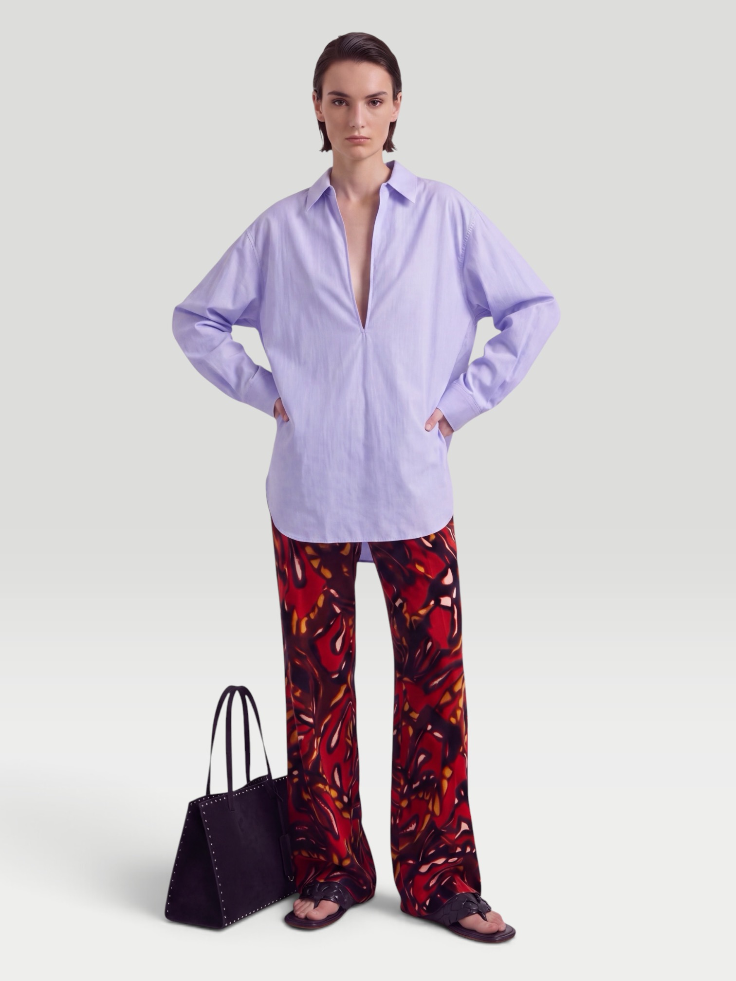 SSSTEIN Skipper Cotton Shirt in blue, worn with Dries Van Noten Printed Cotton-Blend Wide-Leg Pants, Bottega Veneta Salsa Flat Thong, Phoebe Philo Small Stud Cabas Tote Bag, Bottega Veneta Cat-Eye Acetate Sunglasses, the day. Styled by Sharon Lombardo for FDV Concierge.