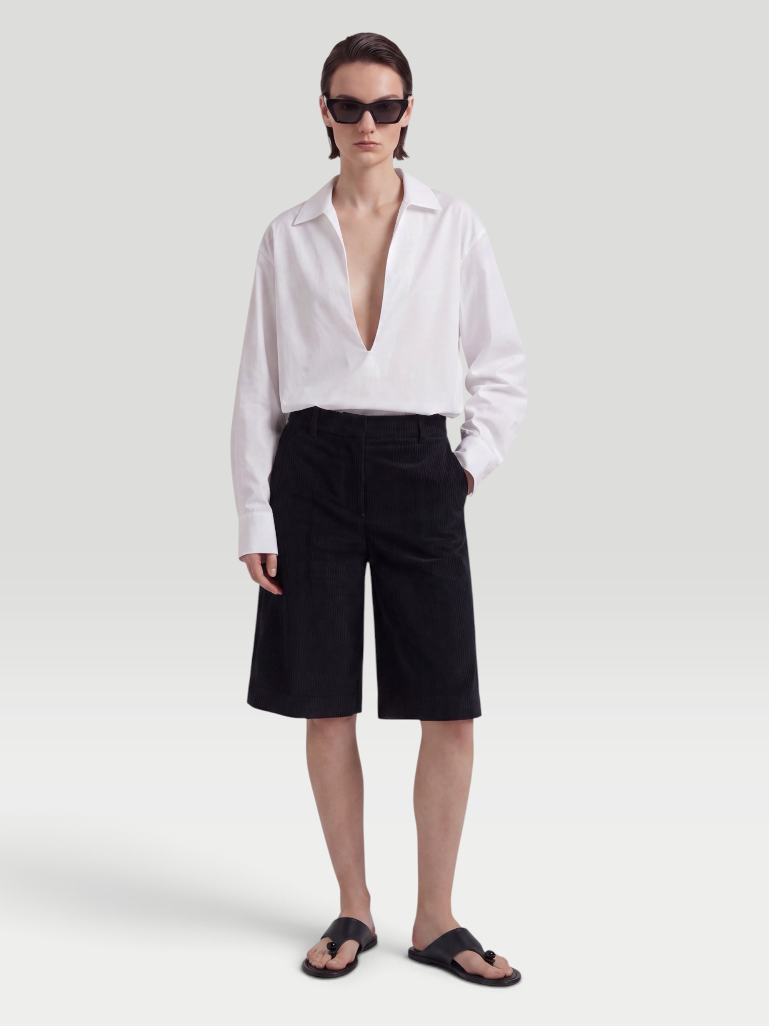 SSSTEIN Skipper Cotton Shirt in white, worn with Levi's 501 Original Short, Manolo Blahnik Susacru Leather Sandals, Loewe Leather-Trimmed Raffia Tote, Loewe Inflated Cat Eye Sunglasses, walking the city. Styled by Sharon Lombardo for FDV Concierge.