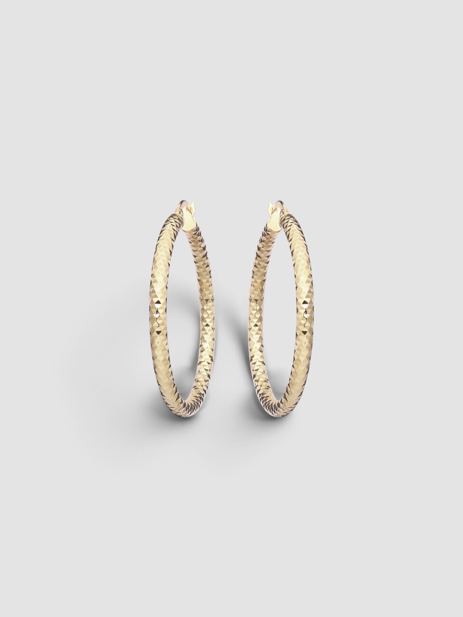 Stone and Strand Bold Sparkle Medium Hoop Earrings in gold.